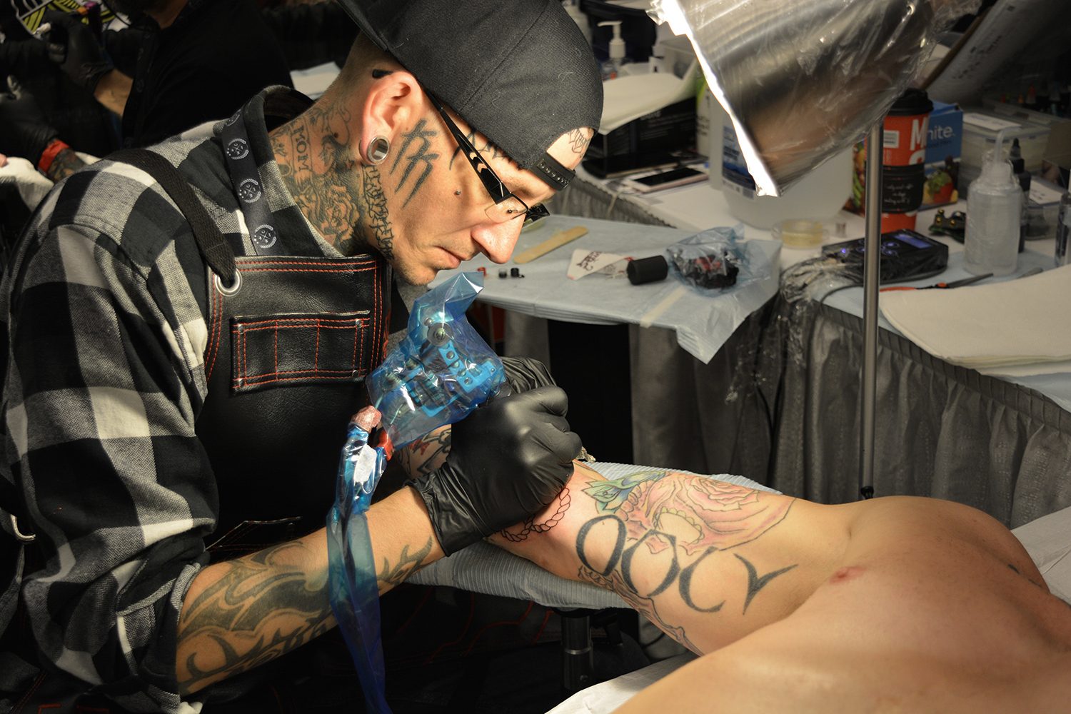 Craig Church tattooing on arm, at canada tattoo convention