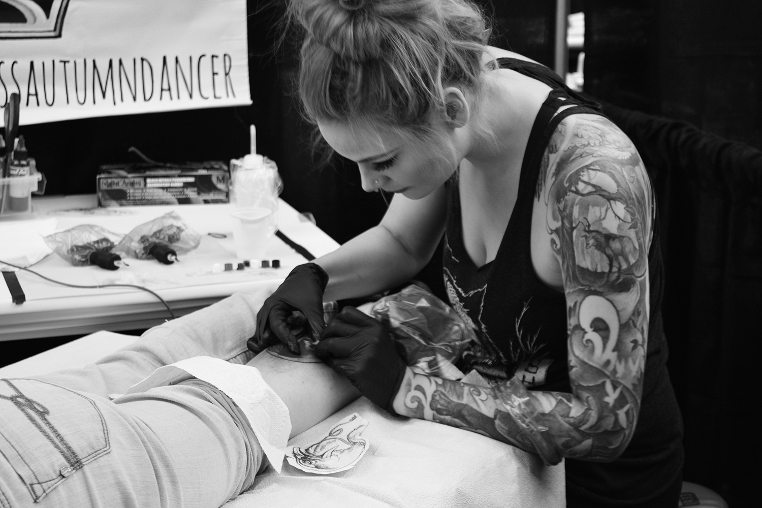 Autumn dancer tattooing client, at tattoo convention