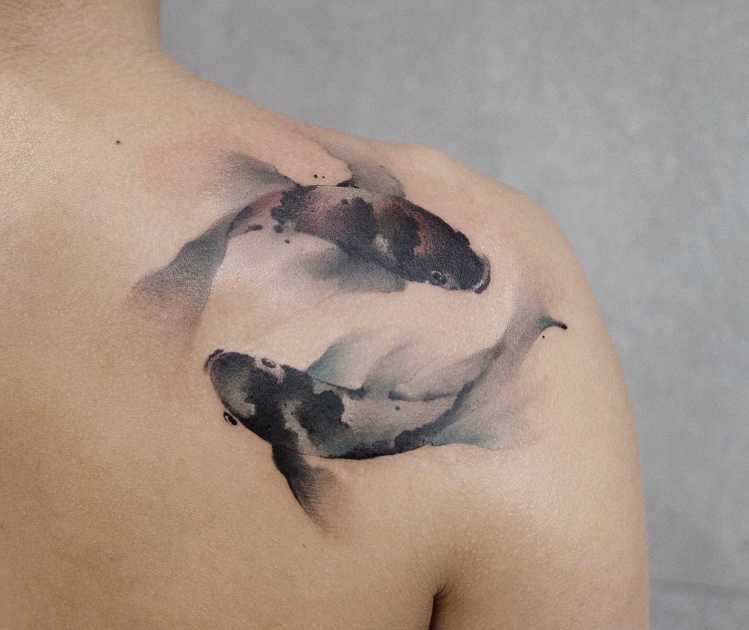 koi fishes, tattoo on shoulder