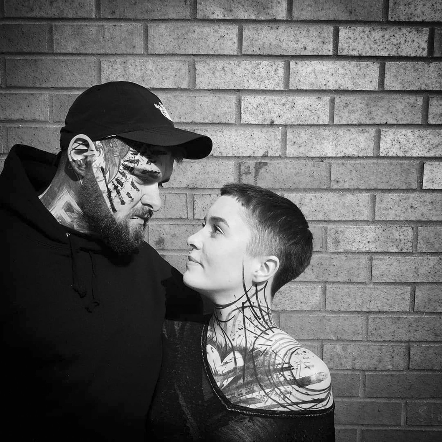 romantic couple with blackwork tattoos