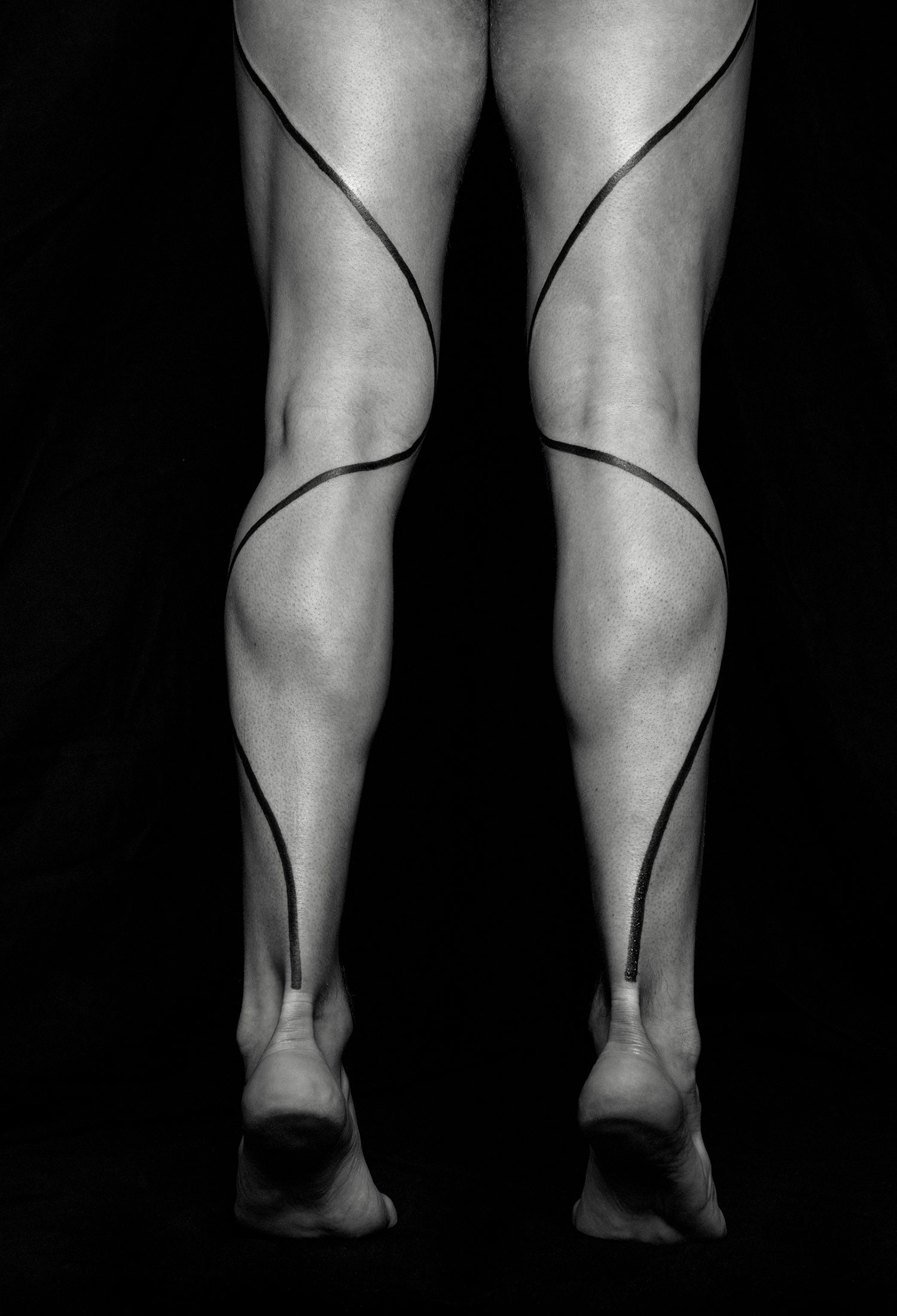 line tattoo on legs by chaim machlev. photo © erik weiss