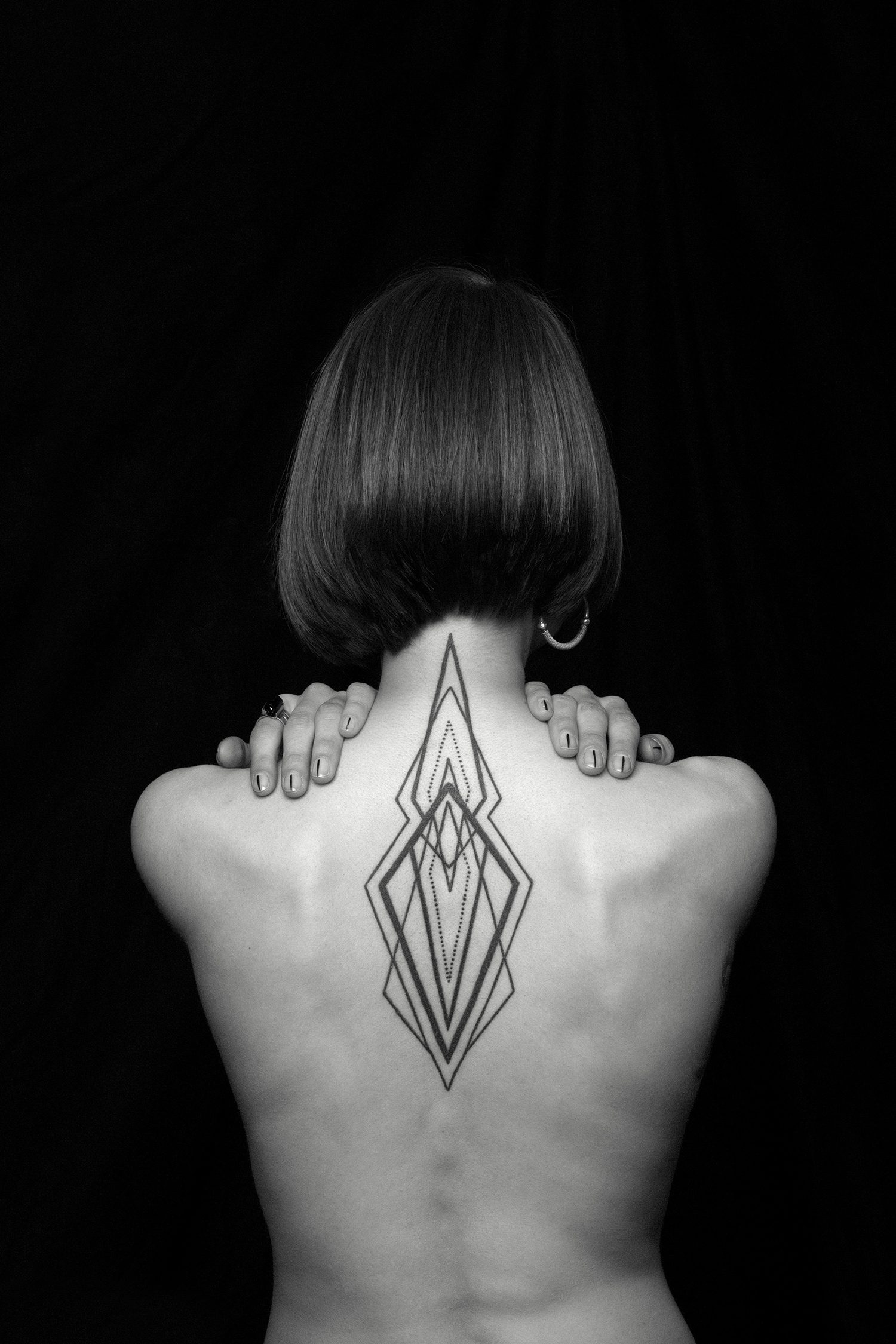 geometric tattoo on back by chaim machlev. photo © erik weiss