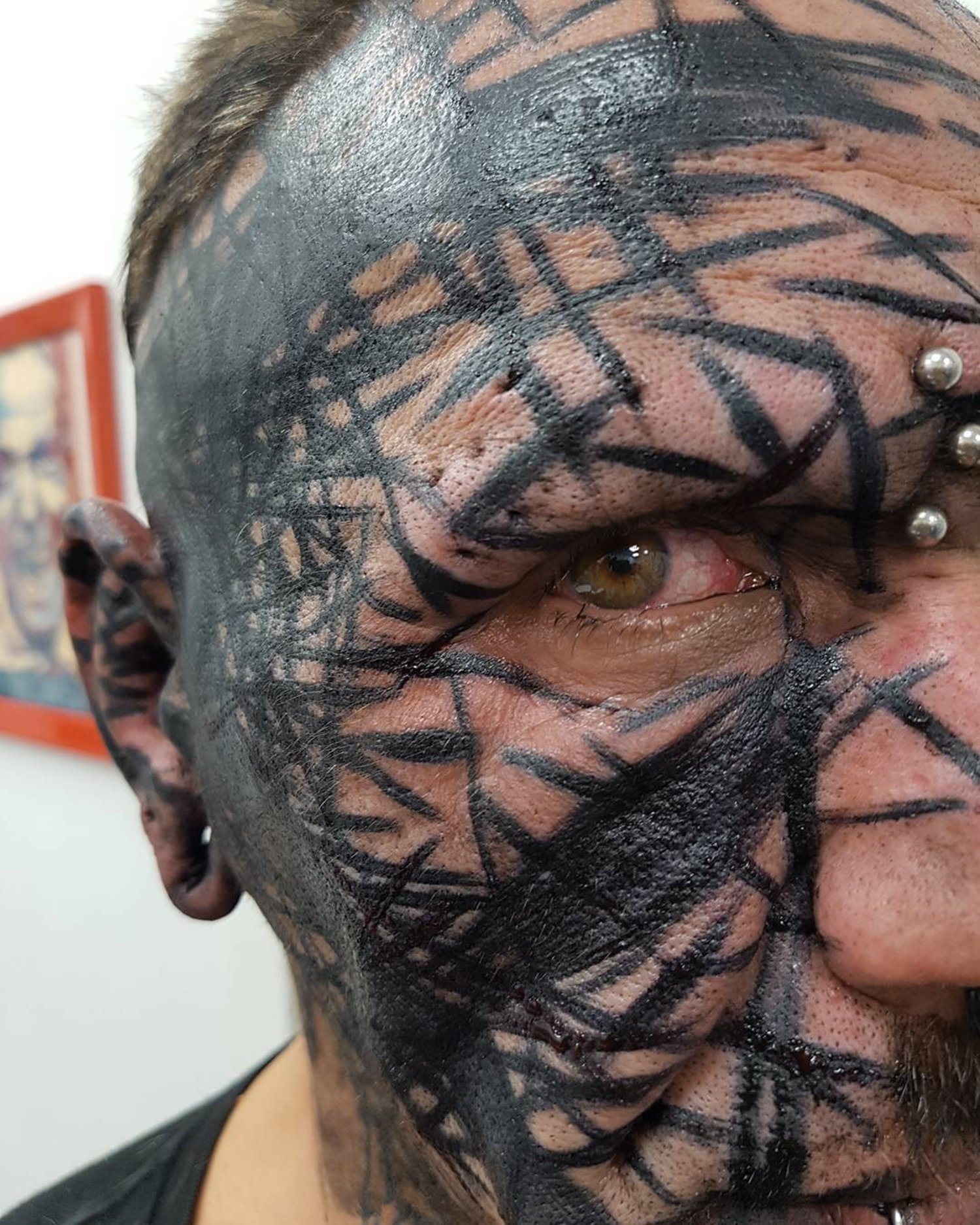 close up of tattooed face , brutal black project