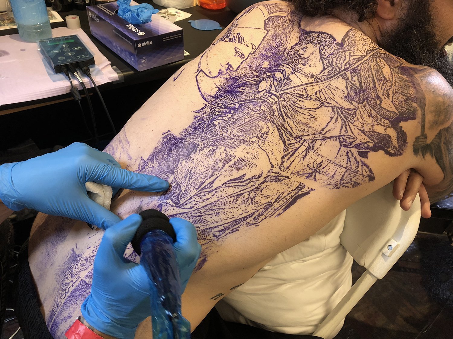 stencil on back, tattoo by marc roy