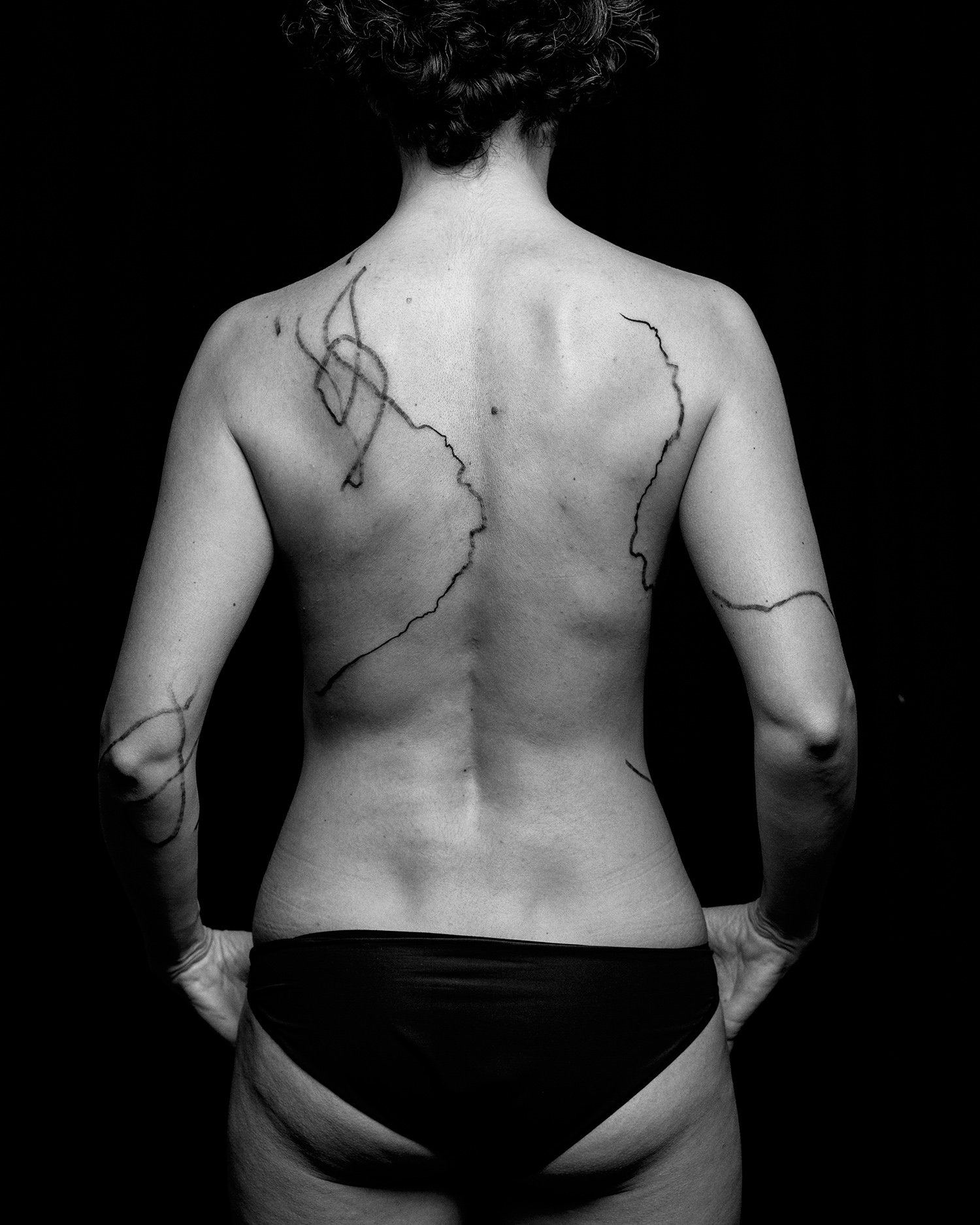 Marcela's back, flow of lines, abstract tattoos, black ink