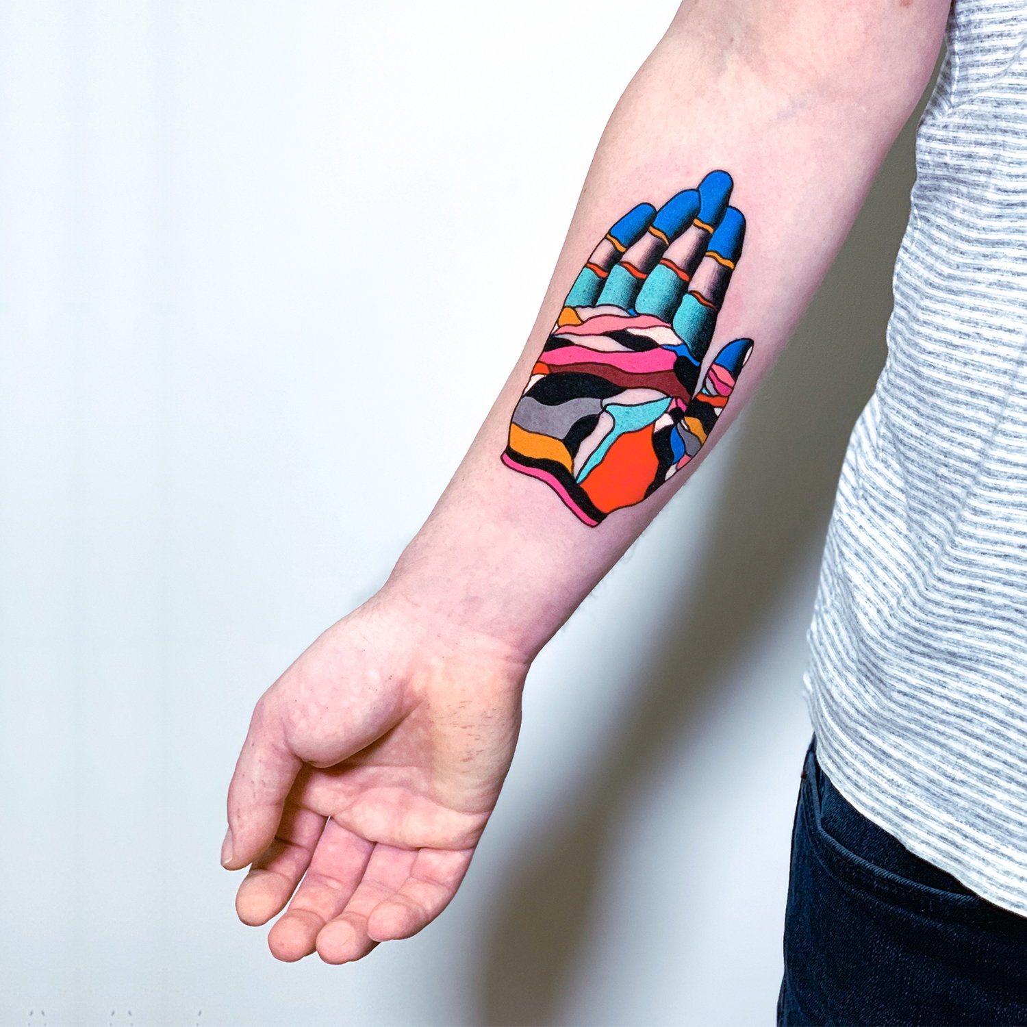 color hand tattoo on arm