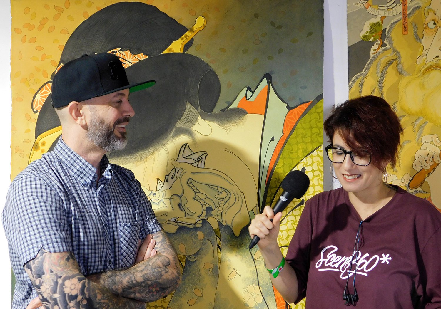 Chris Garver and interviewer Adriana de Barros, in London Tattoo Convention, Photo © Scene360