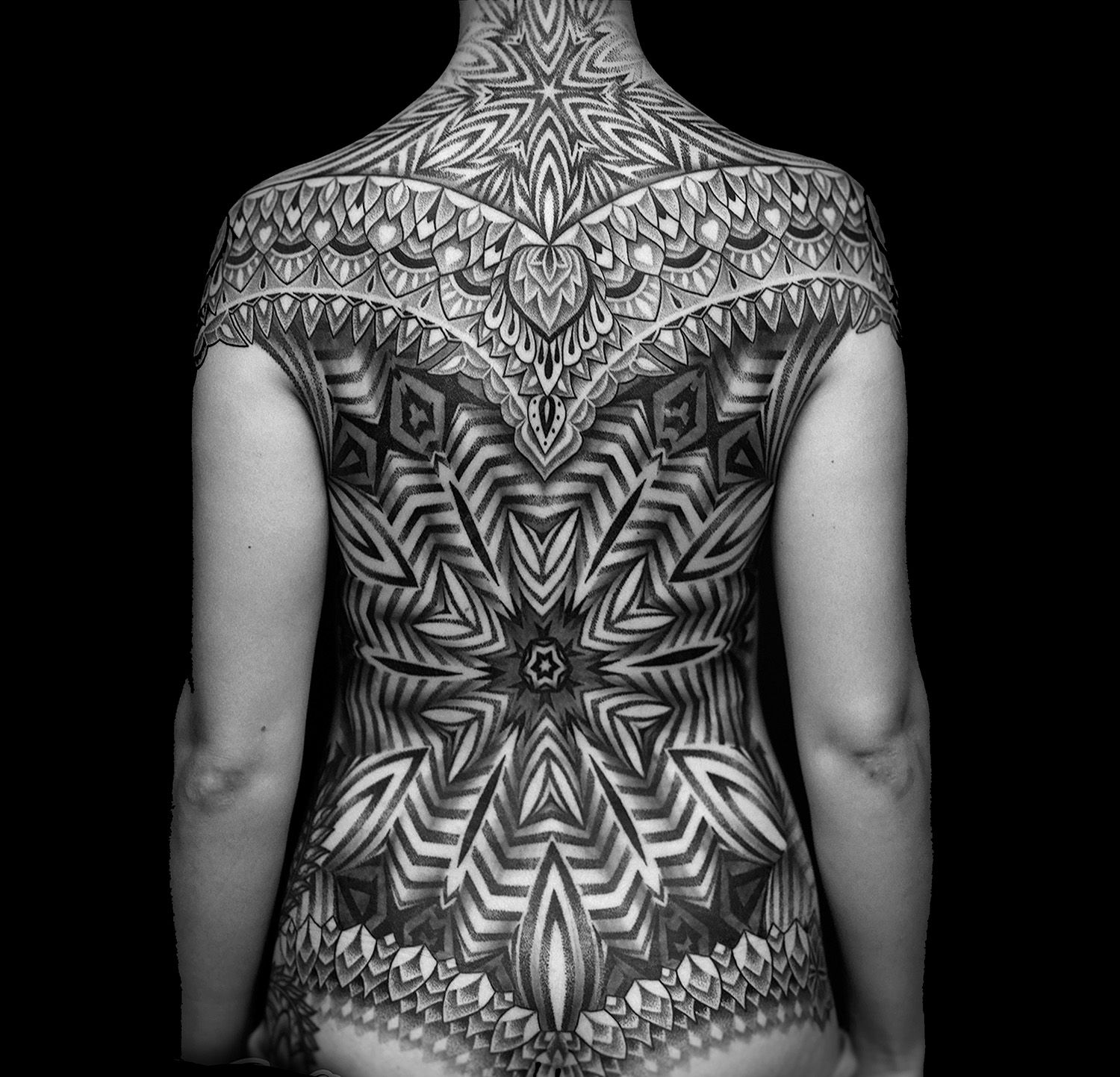 ornamental, meticulous blackwork, geometric pattern on back, tattooed