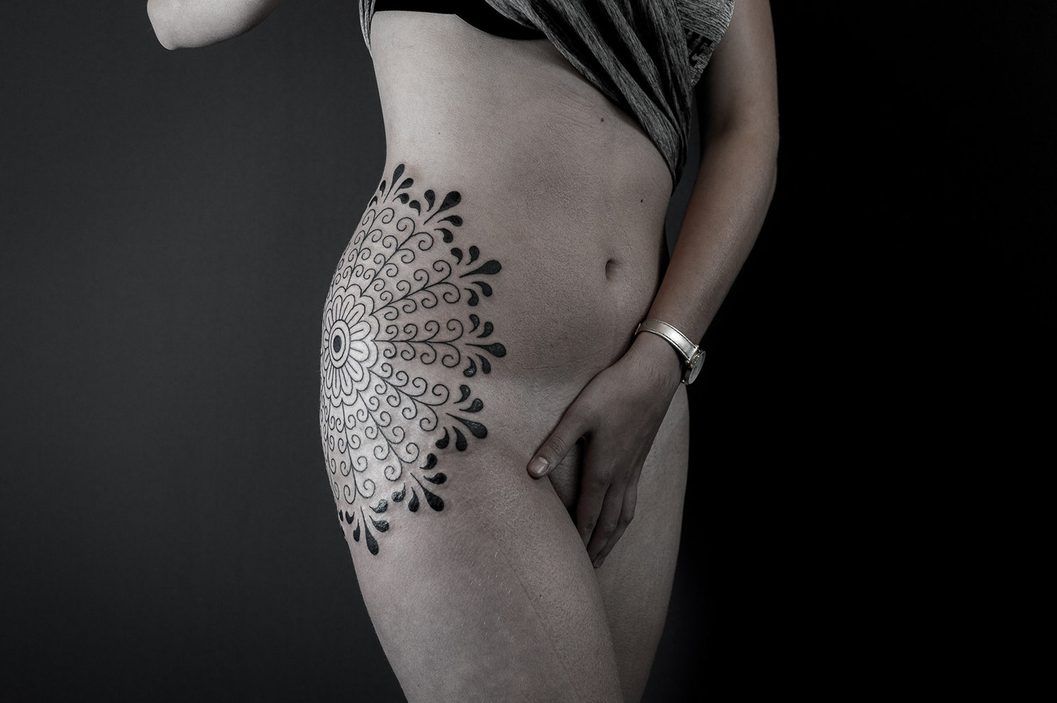 hip tattoo, black ink, mandala like by paradox NL