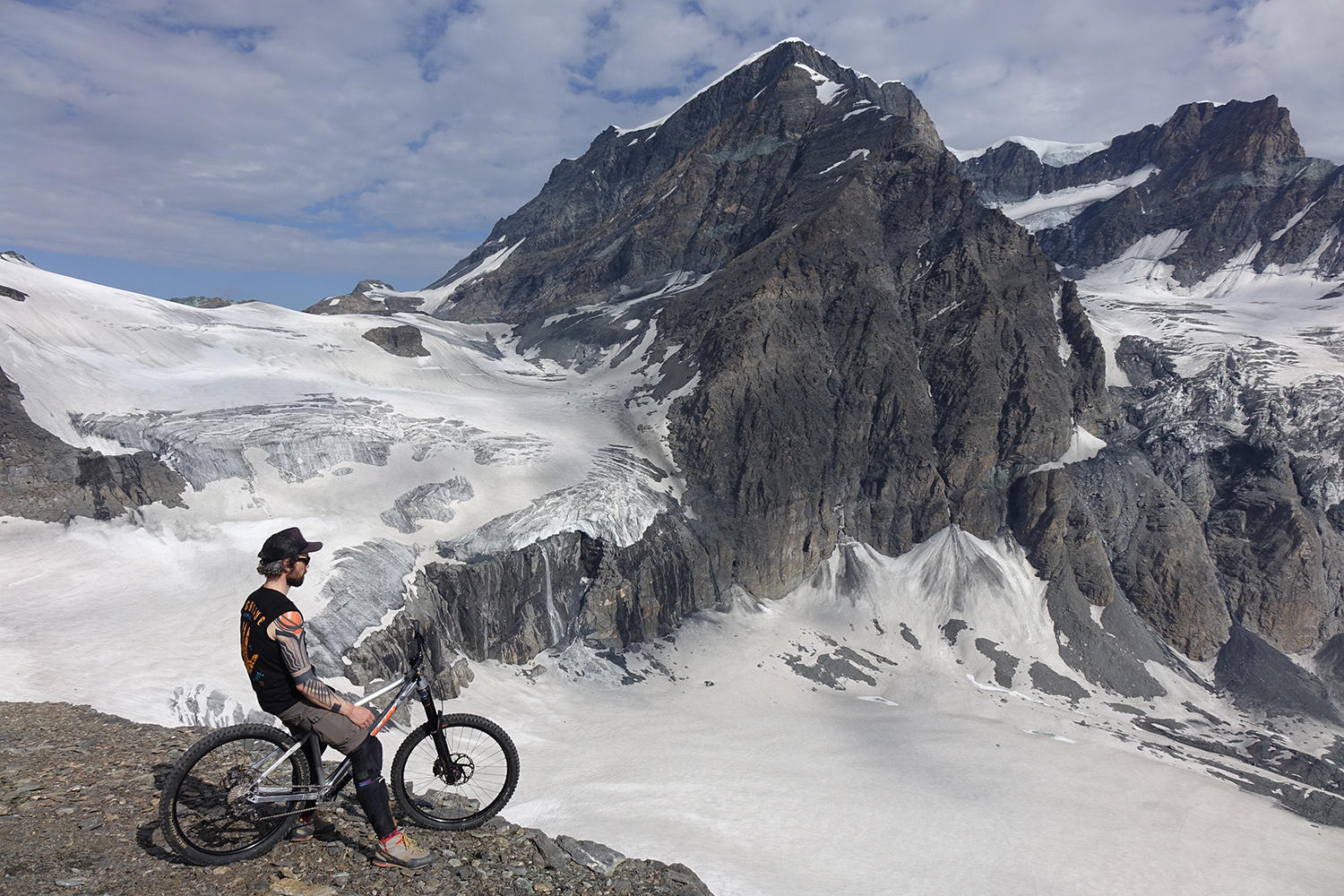 tattooed man in mountains, outdoor, dane tattoo