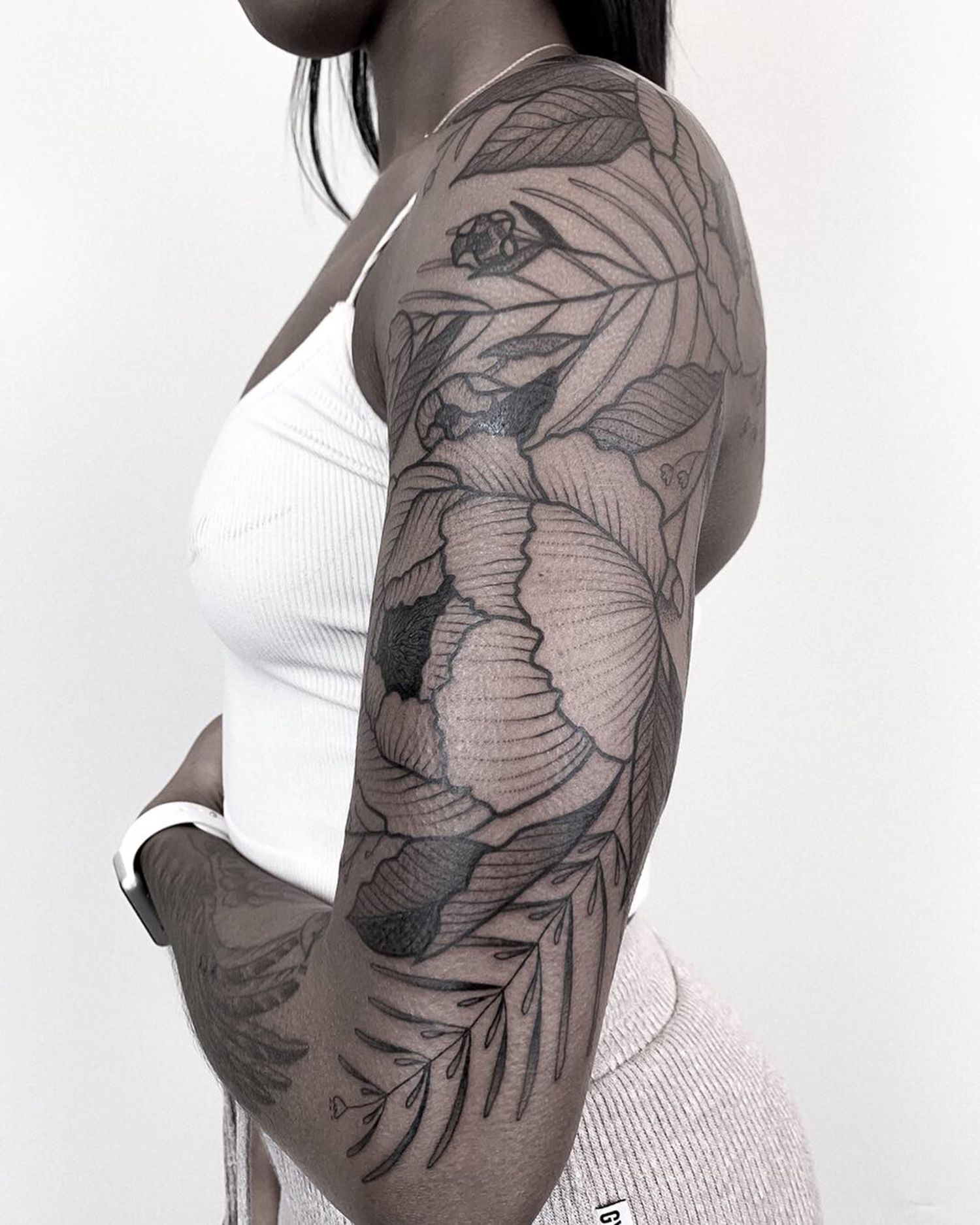 black woman, tattoo on arm, blackwork, botanical