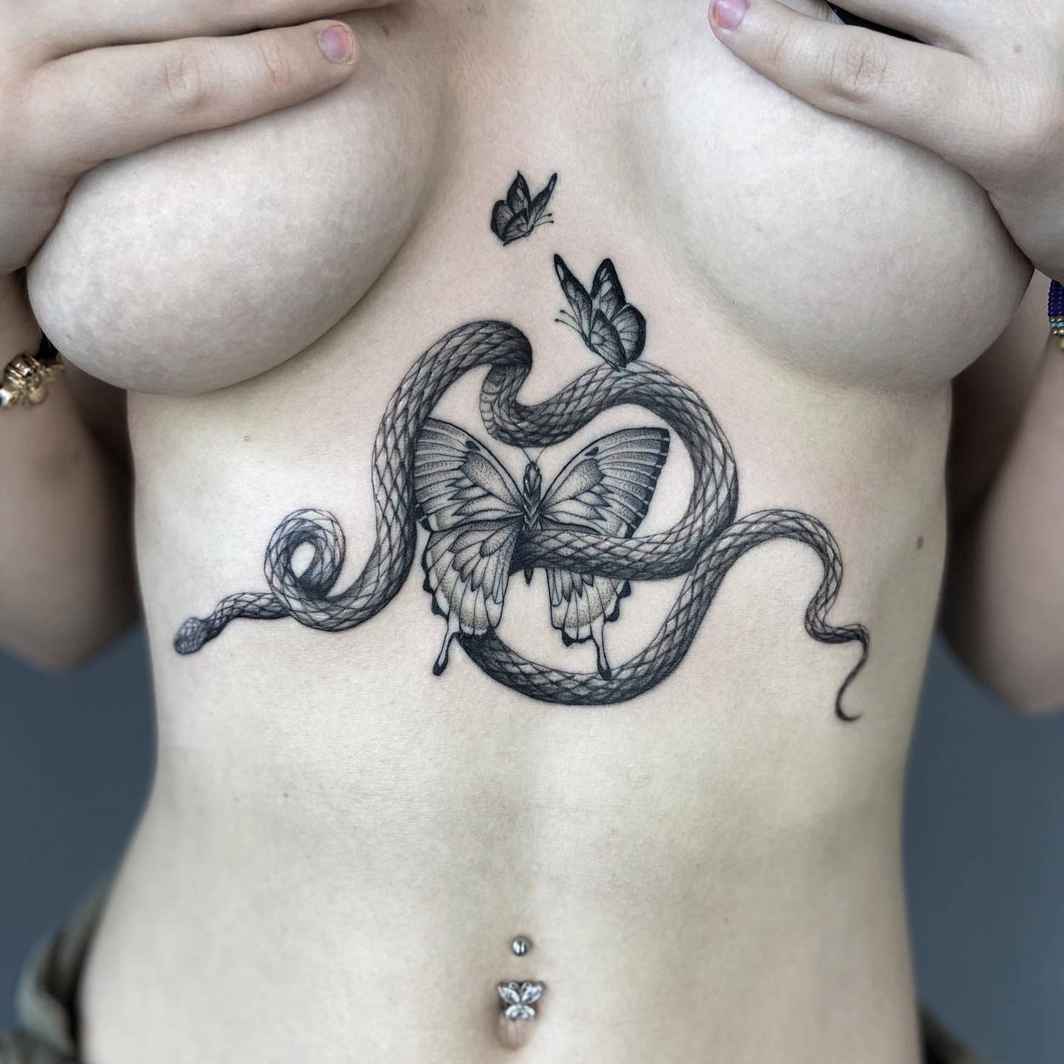 butterfly and snake, fine-line tattoos on torso by delphin musquet, sang bleu london