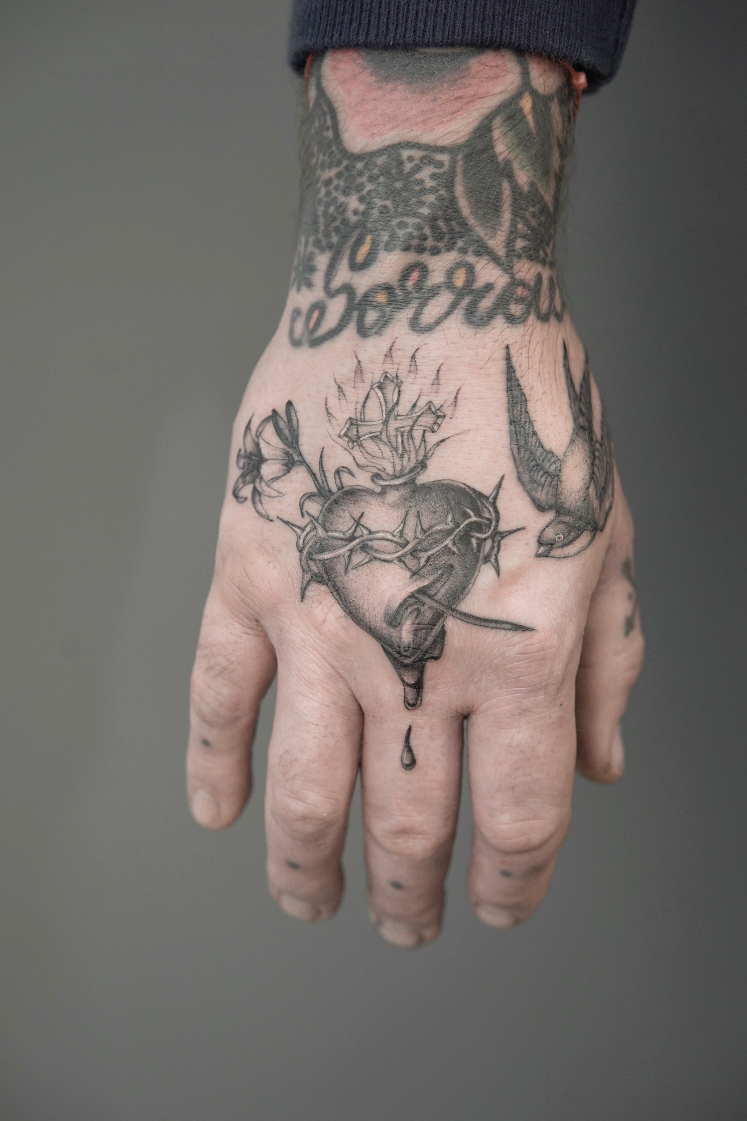 sacred heart tattoo on hand by delph musquet