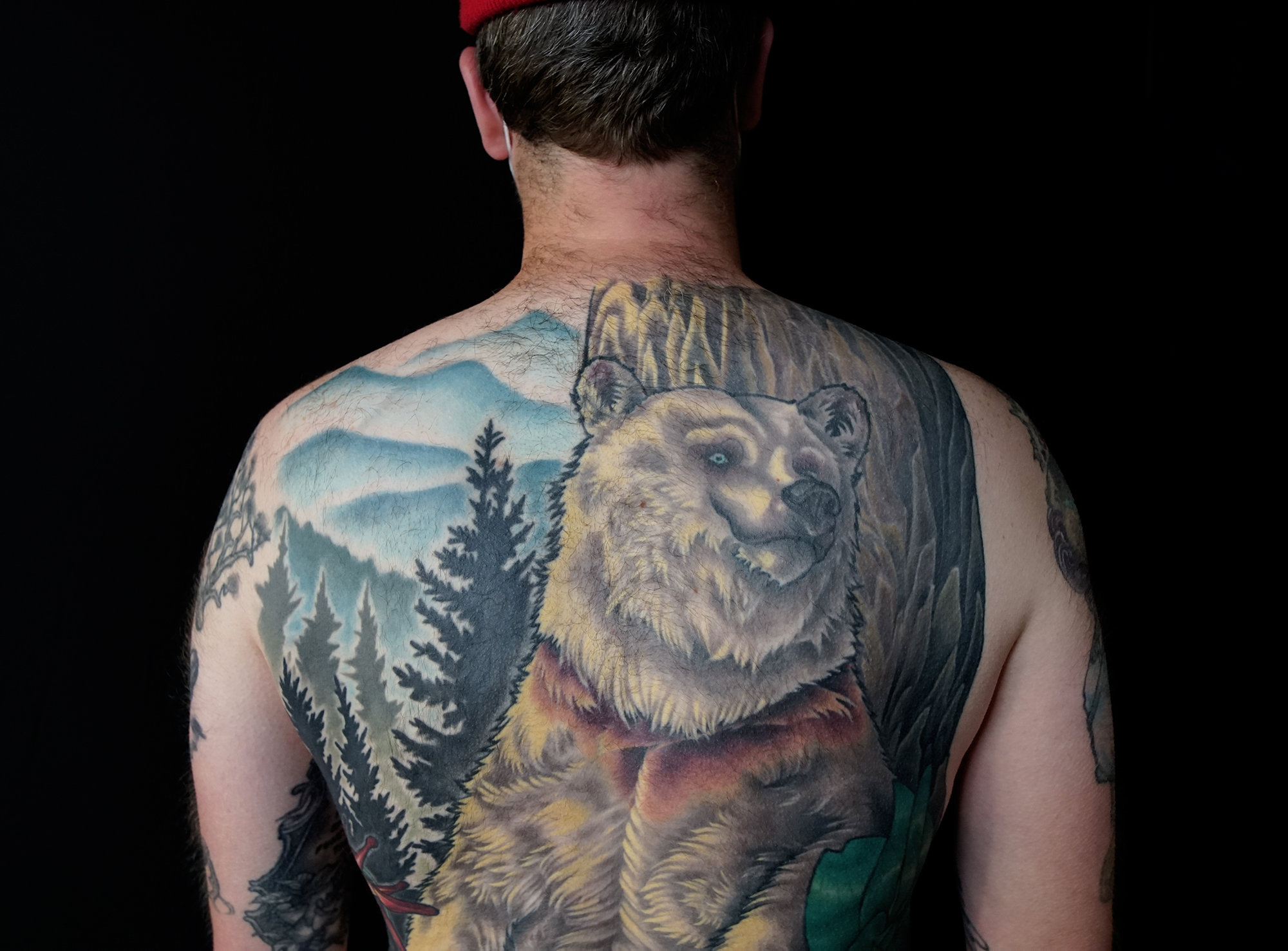 Back color tattoo, nature theme with big bear and plants by hannah wolf