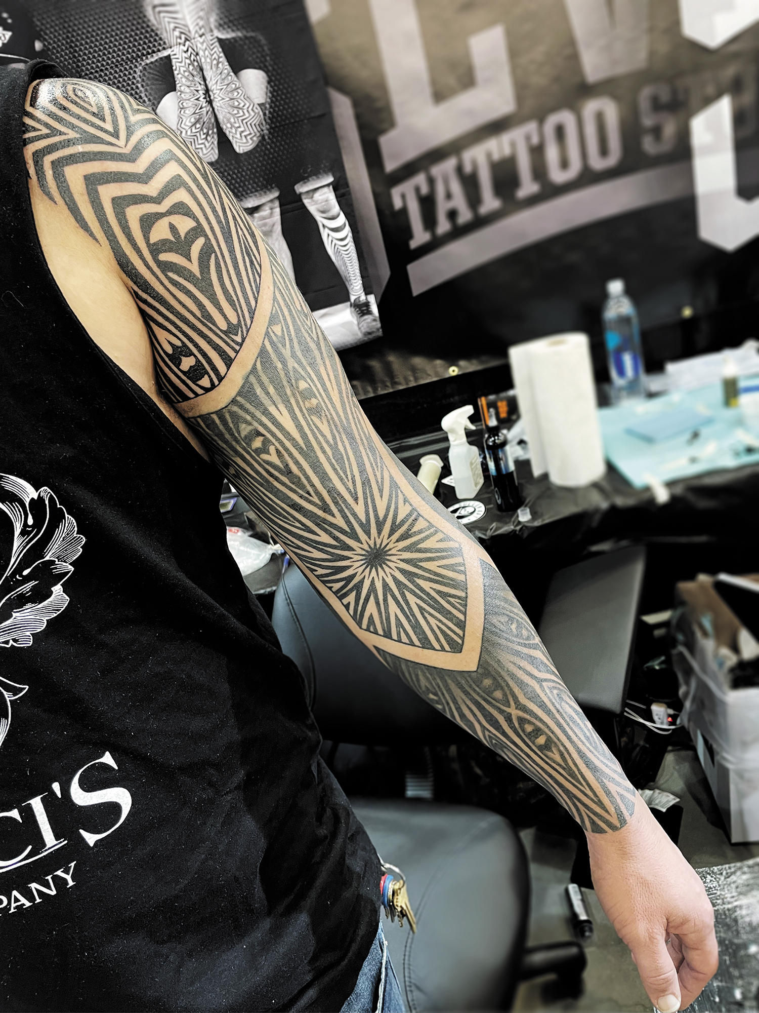 A dotwork ornamental tattoo sleeve by Ilya Cascad.