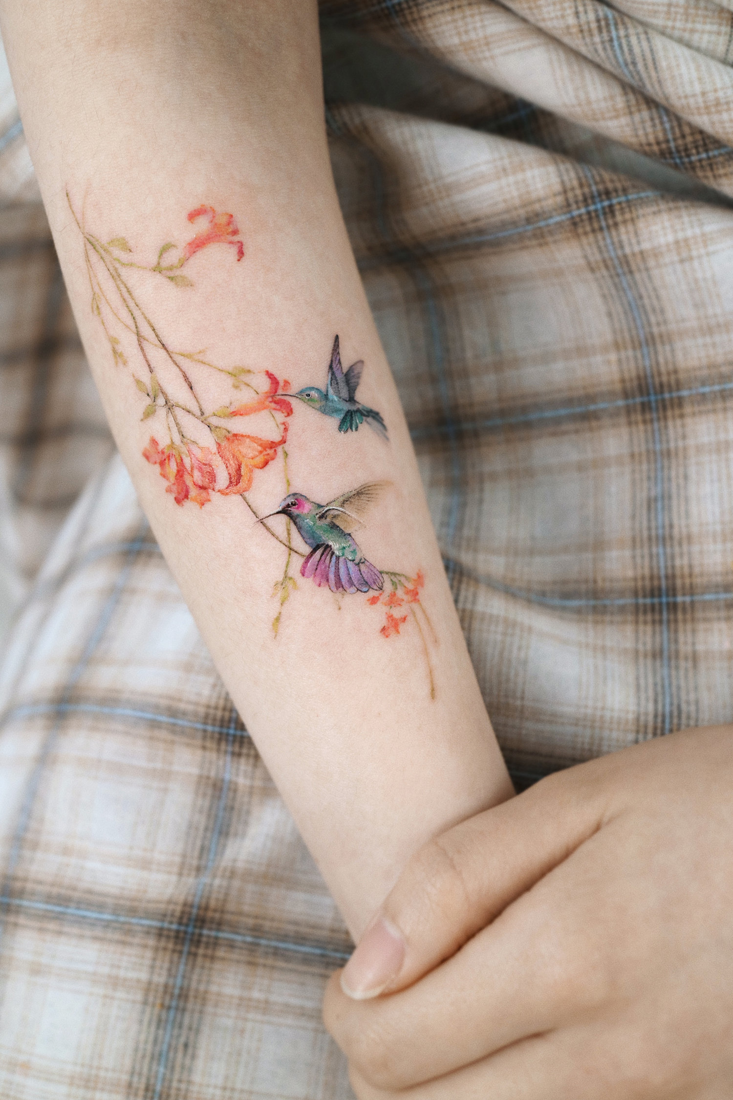 Hummingbirds inked in a fine-line style.