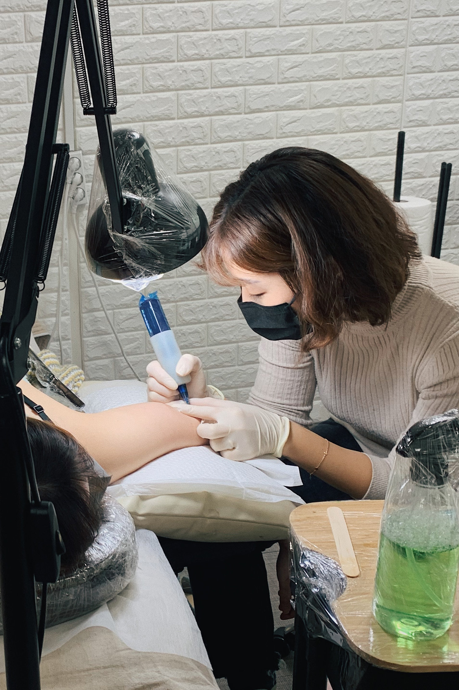 Abii, a tattooist from South Korea, in studio.