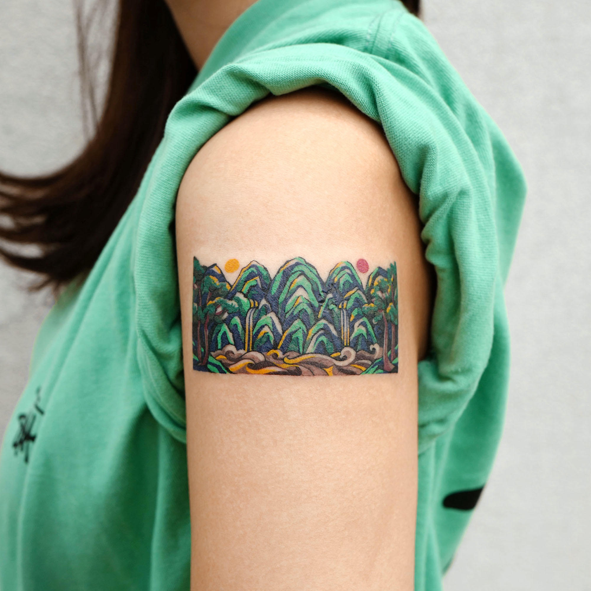 asian mountain scene, tattoo on arm by eden