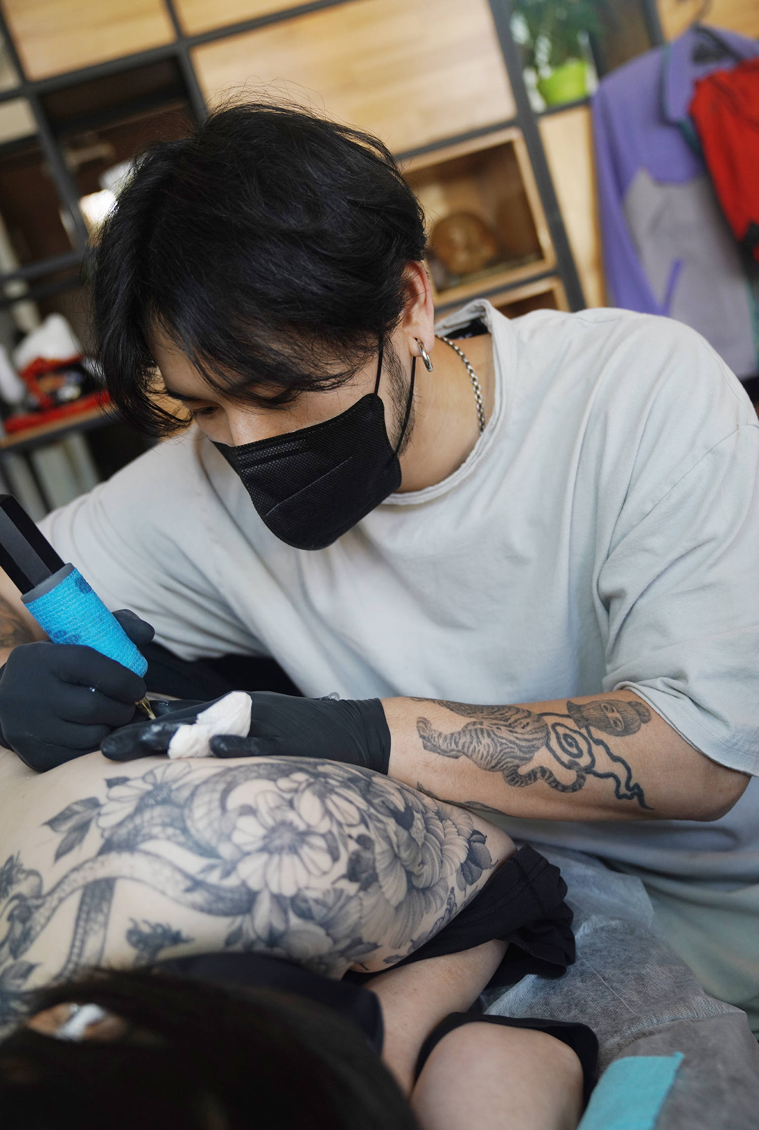 Zee, a tattoo artist from South Korea, at a private studio.
