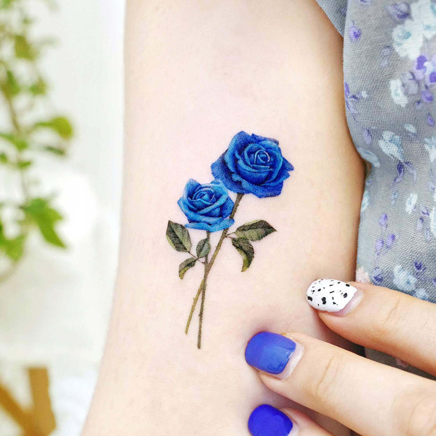 Blue flowers executed in a meticulous, micro-style. Tattoo by Songe.