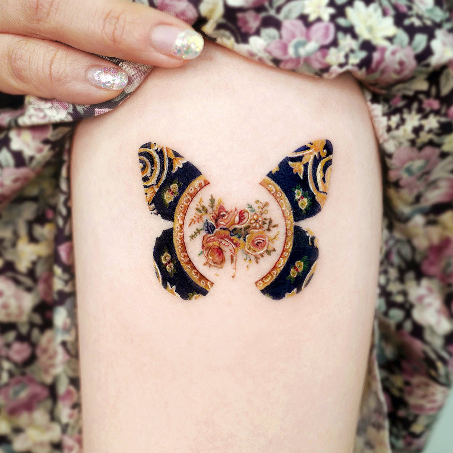 Vintage imagery inspires tattooer Songe. Butterfly and flowers.