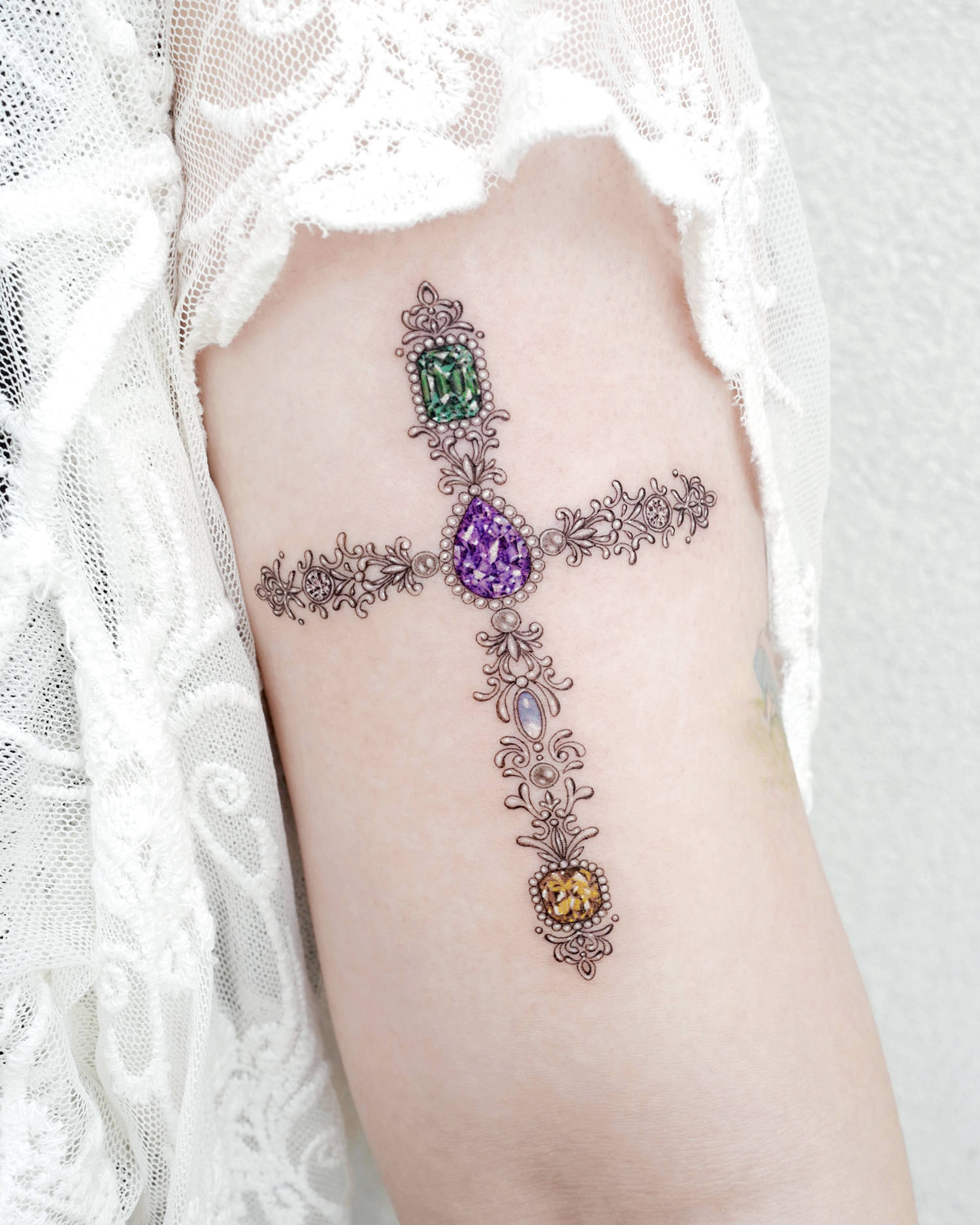 A past-century inspired gemstone cross.