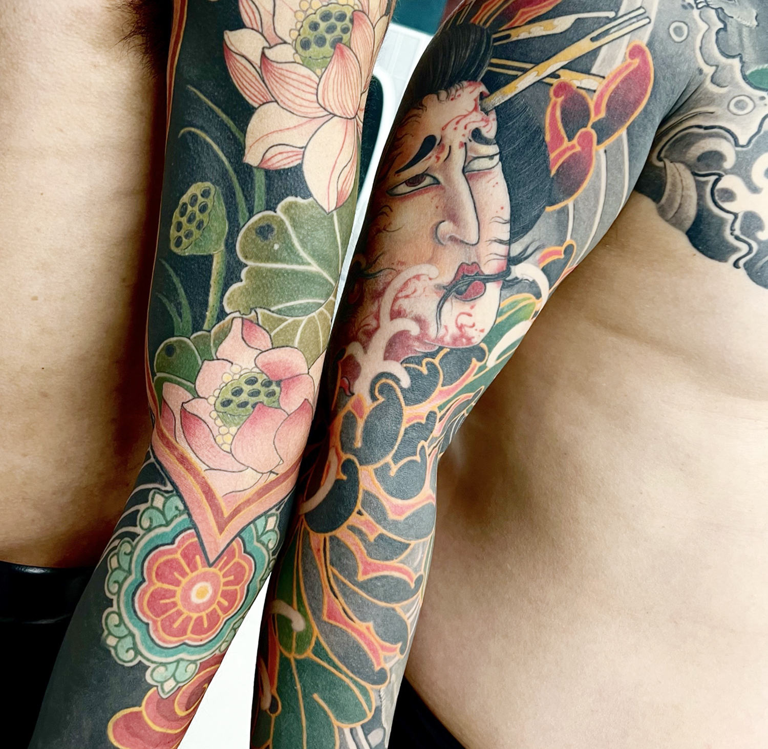 One sleeve has lotuses and the other features chrysanthemums.
