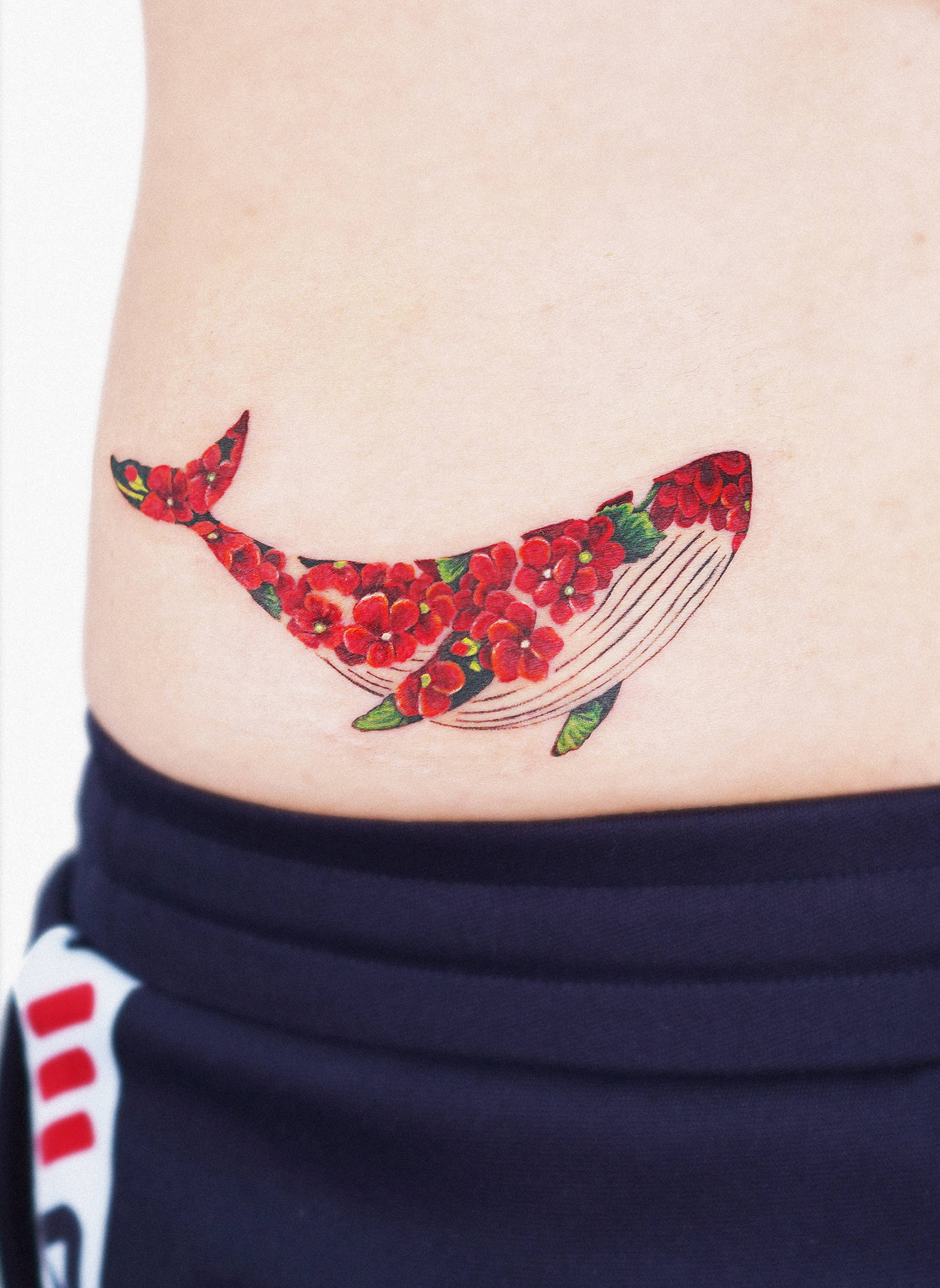 A bright flowery whale on the clients waist