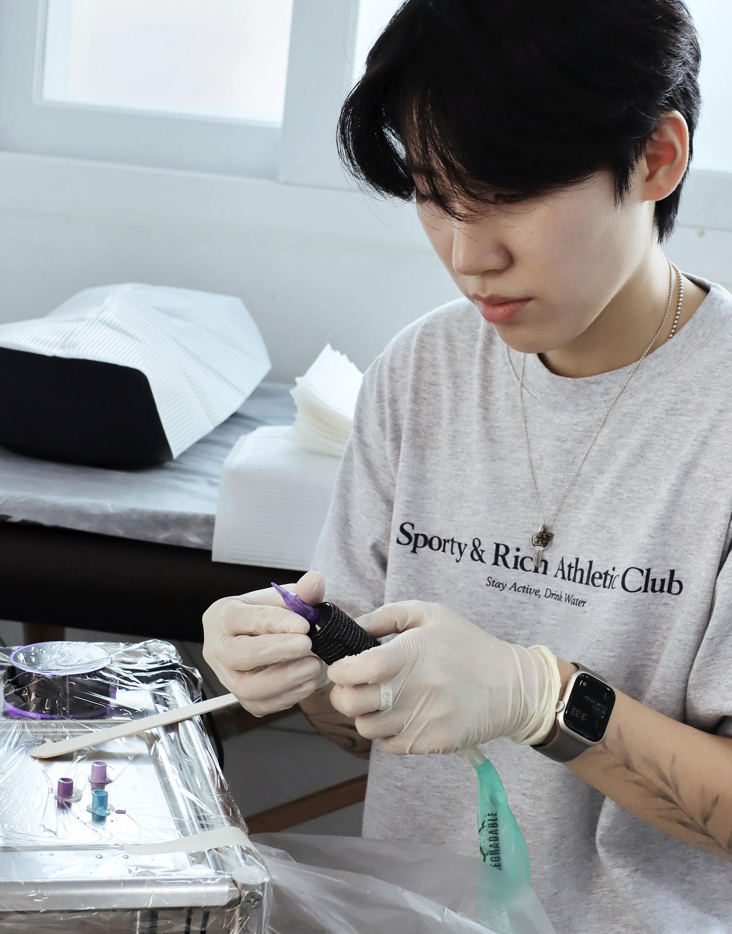 Joojoo, a tattooer from South Korea, prepares her station.