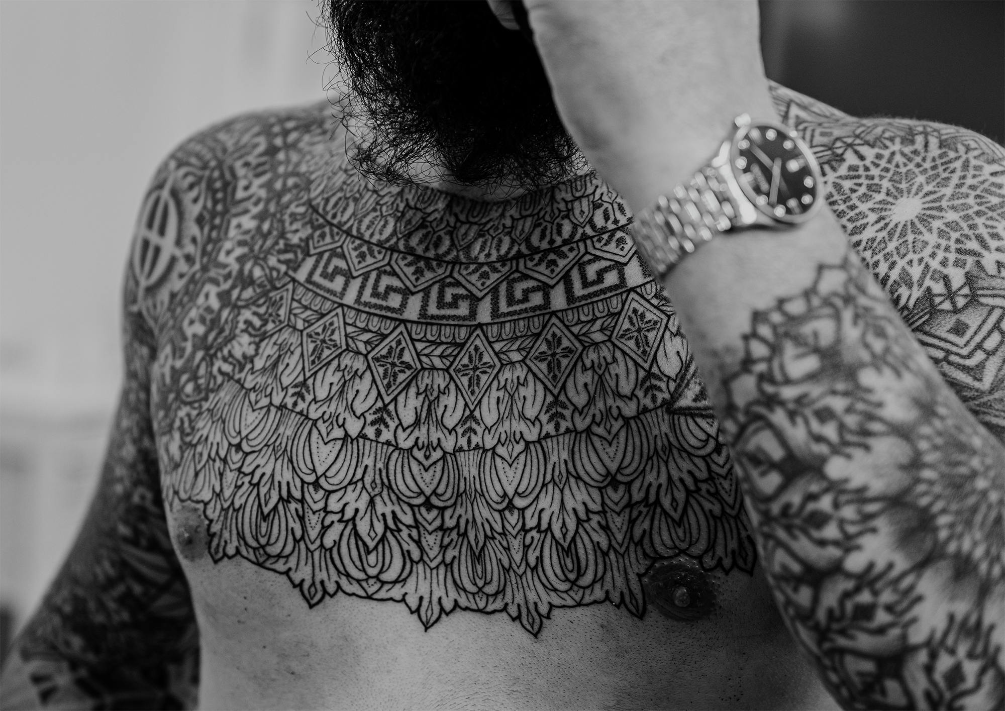 On the chest of his client is one of Nilsen's most intricate tattoos.