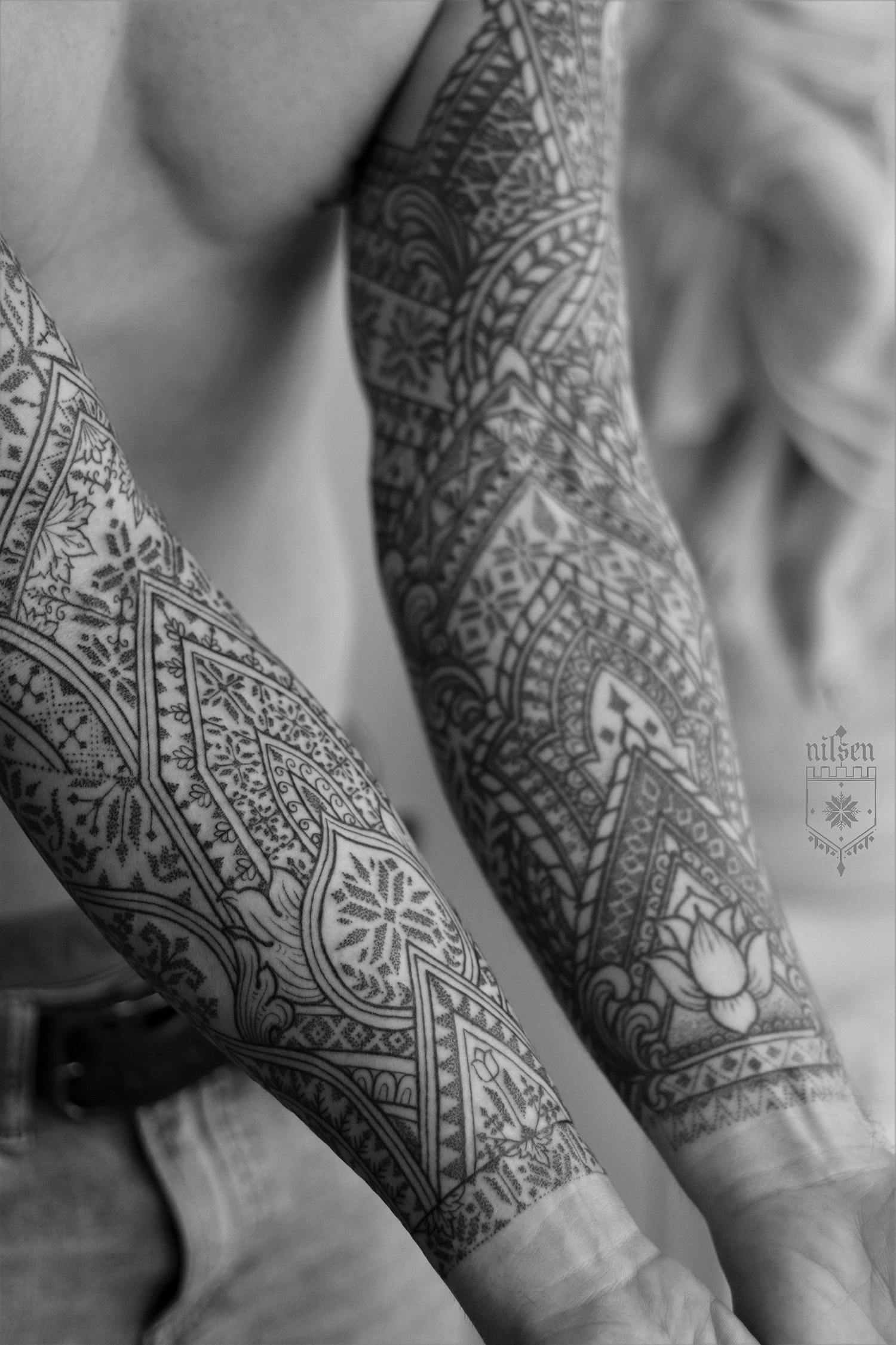 Occasionally, his intricate geometric tattoos mimic cathedral windows and old architectural embellishments.