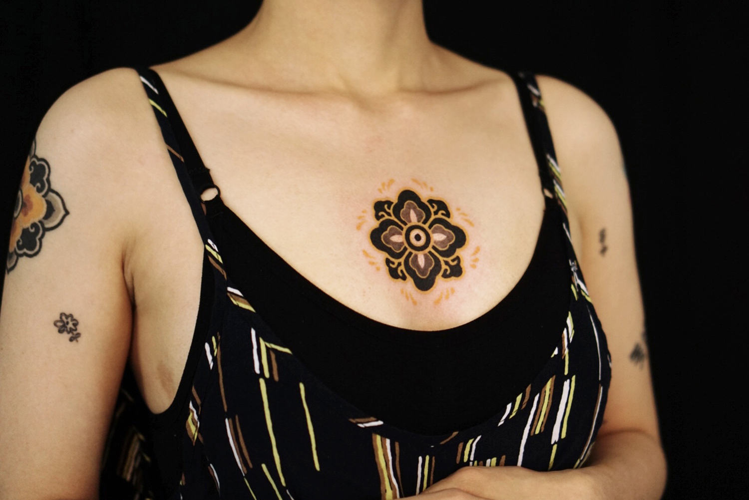 Black and yellow ink tattoo, mandala 