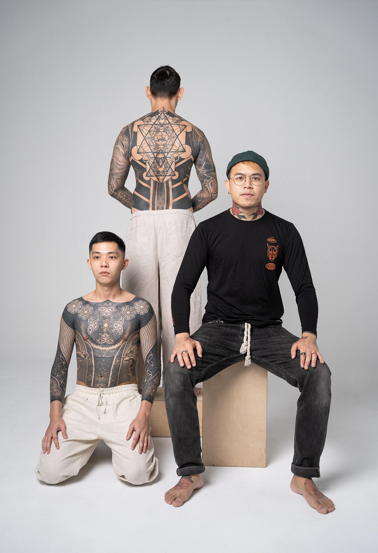 The artist Ian Damien alongside his tattooed clients