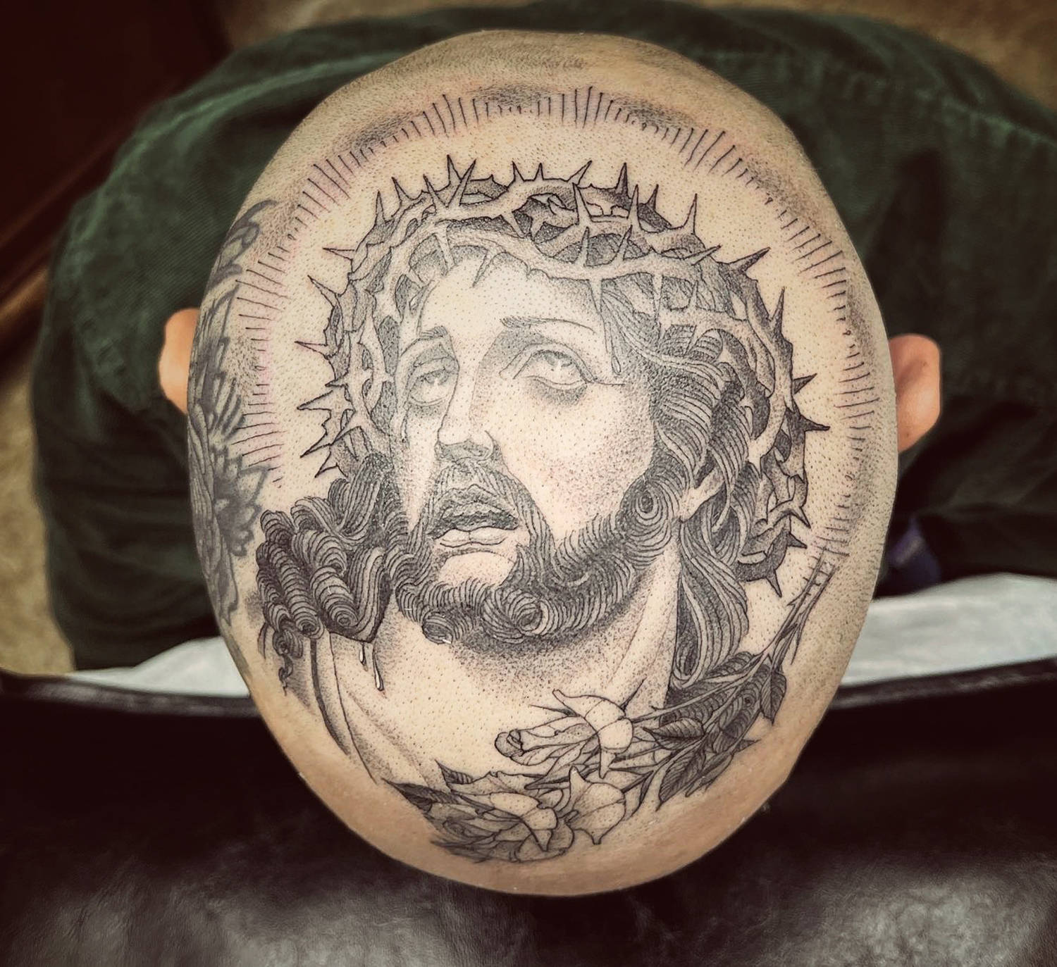 This Christ tattoo is centered and gracefully done with line and dot work