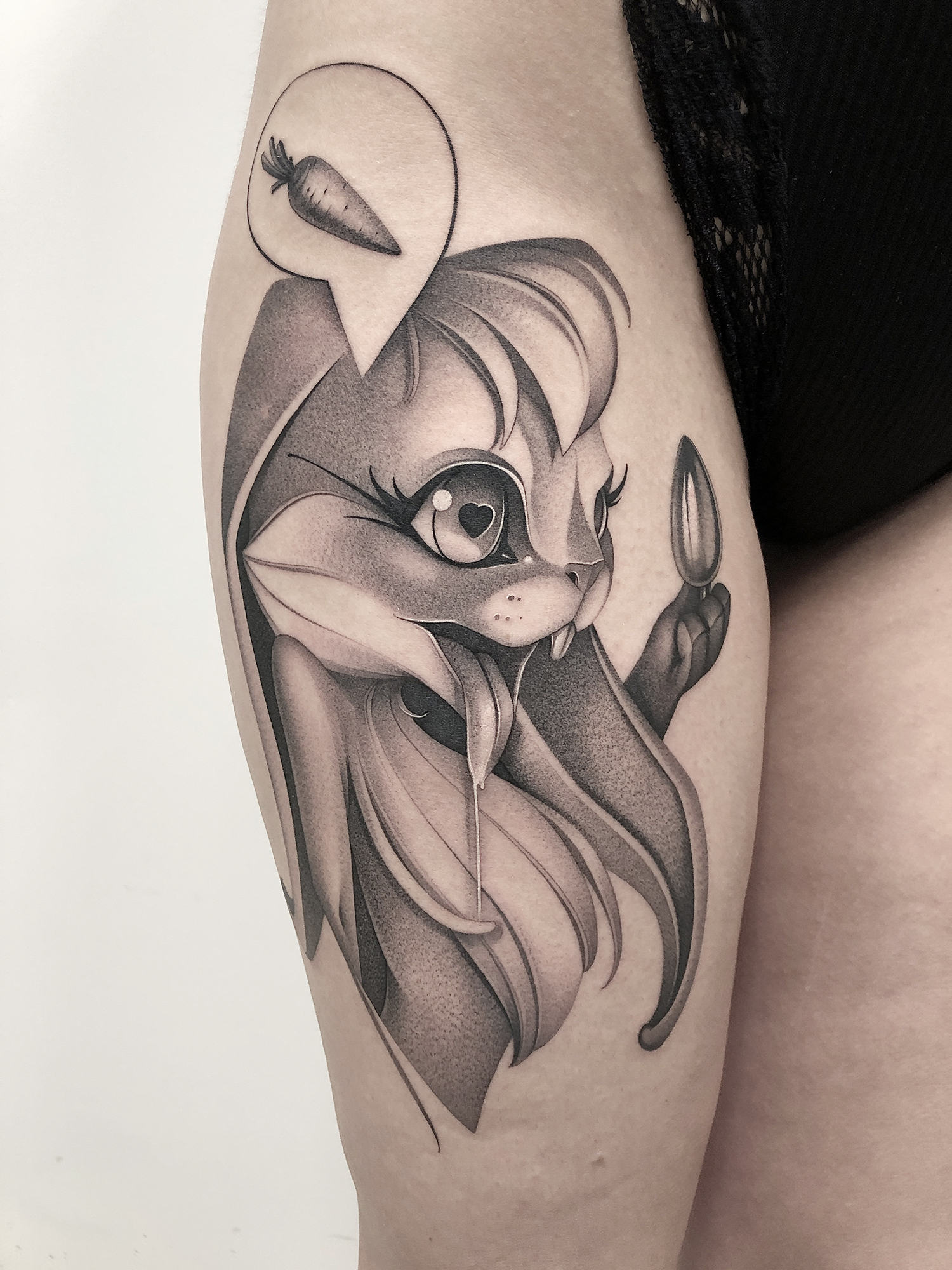 cartoonish rabbit tattoo on thigh