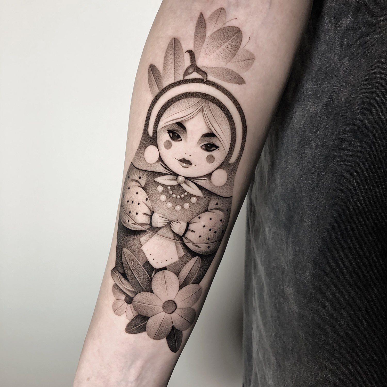 The detailed Russian nesting doll is shown on the client s arm, matryoshka