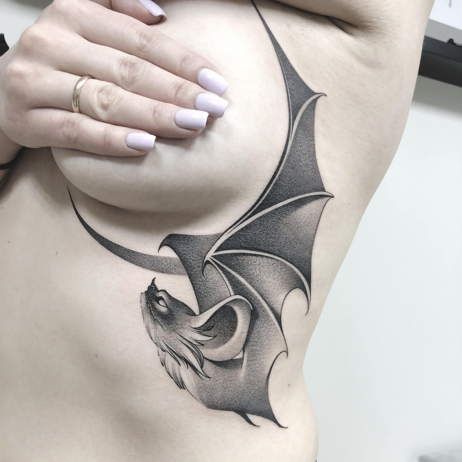 bat tattoo under breast