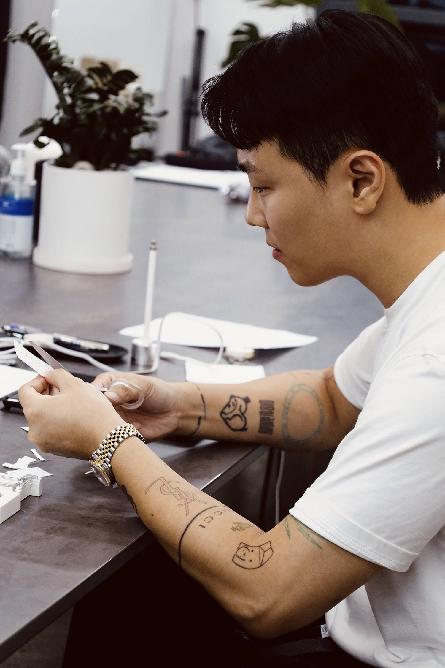 Korean tattooer Sop prepping a stencil for a tattoo
