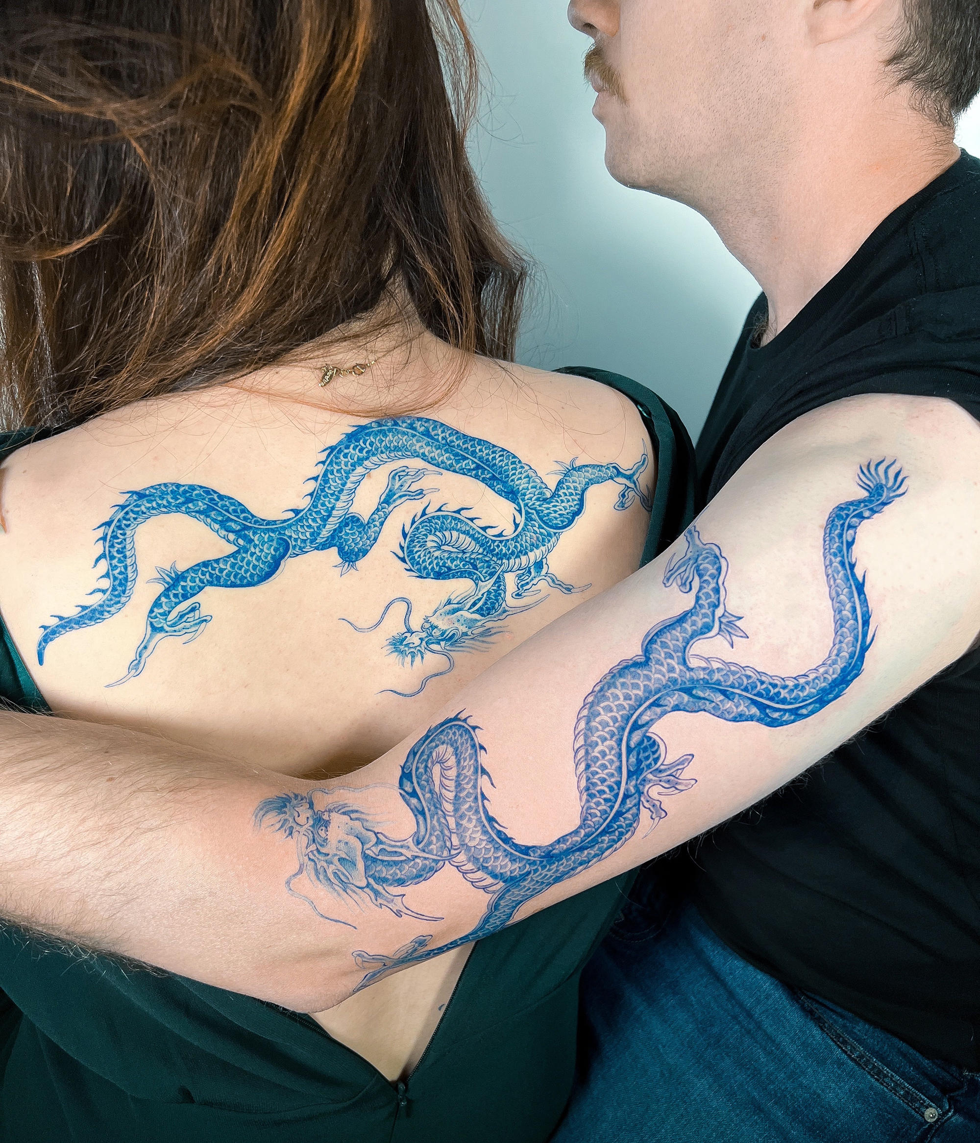 blue ink, fineline tattoos of dragons