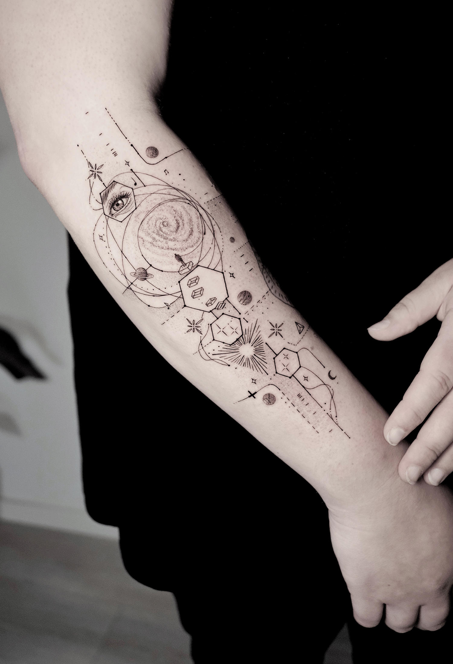 In tattoo form, the galaxy with planets and interstellar matter