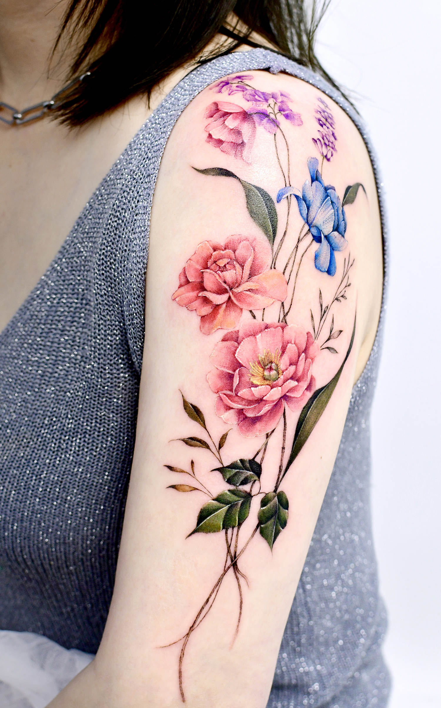arm tattoo with flower boquet by yerae