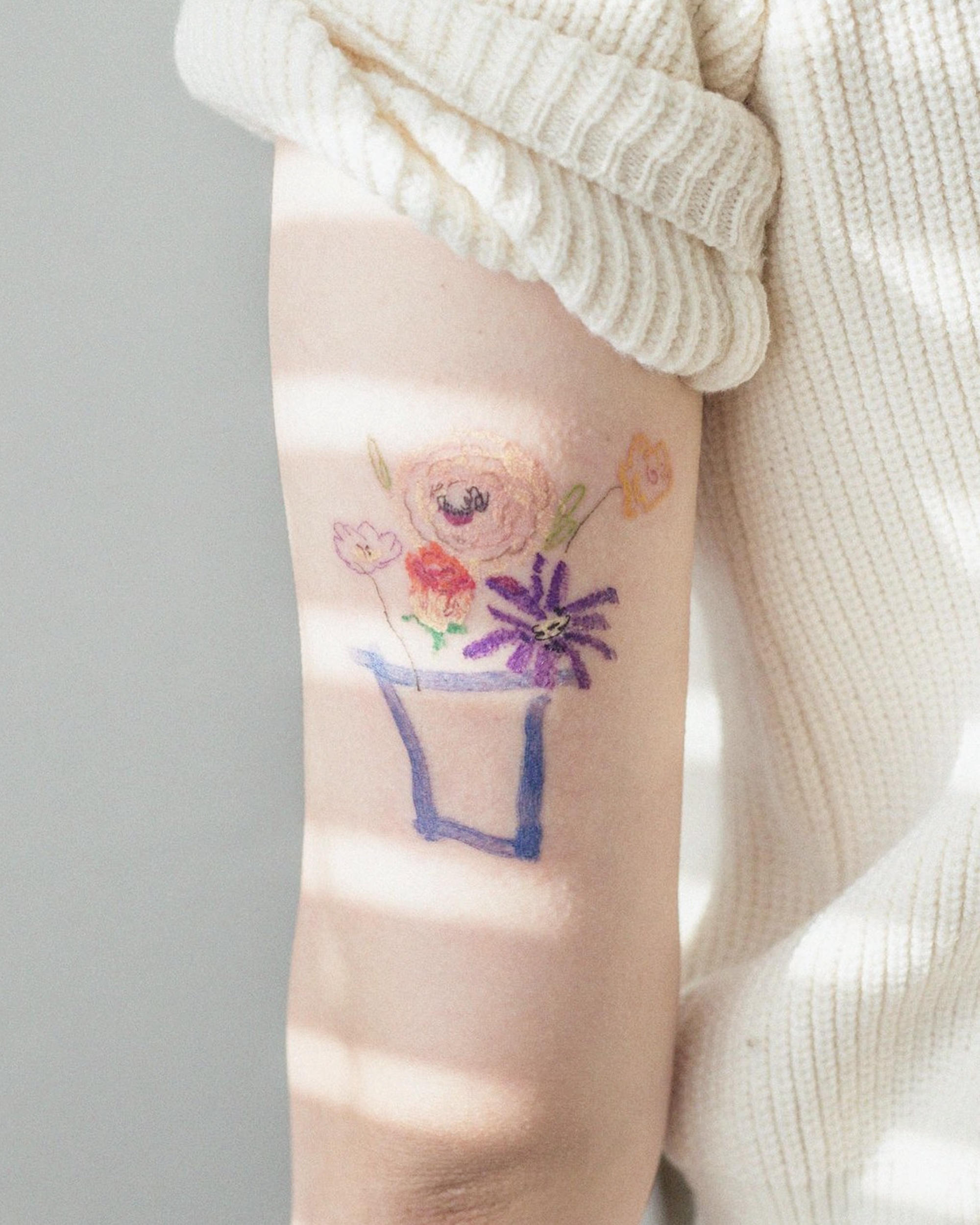 flower arrangement in vase, oil pastel like tattoo on arm