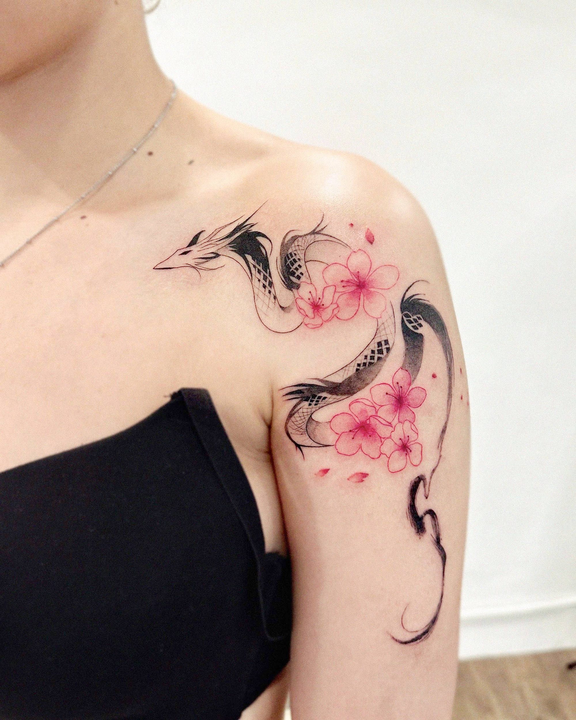 A painterly dragon with cherry blossoms, a tattoo by Ehyang black and magenta on arm