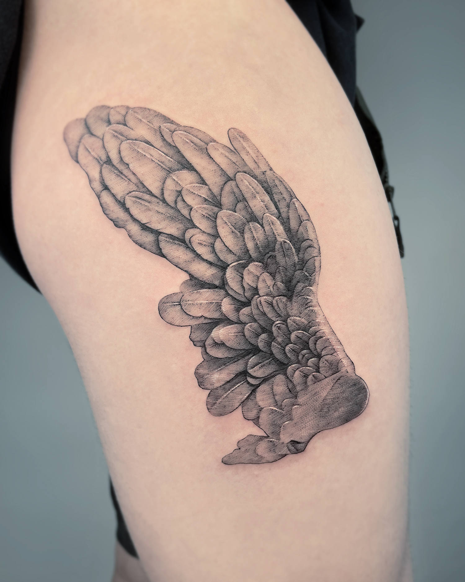 A homage to a Greco-Roman sculpture. wing in stone tattoo