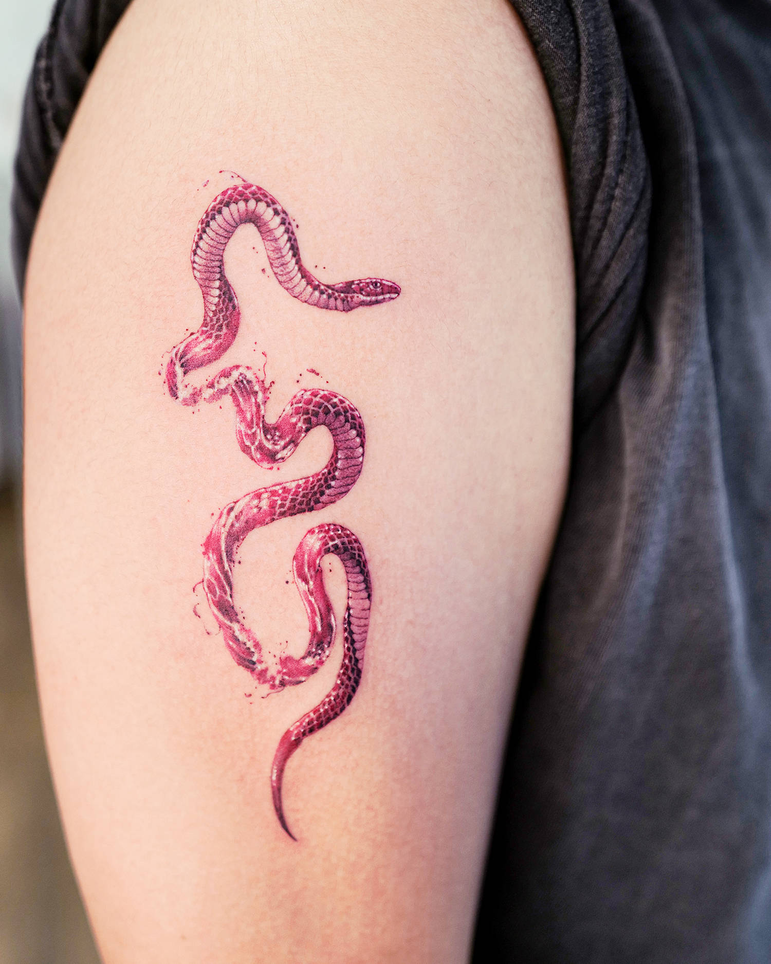 red snake with water wave texture, tattoo on arm