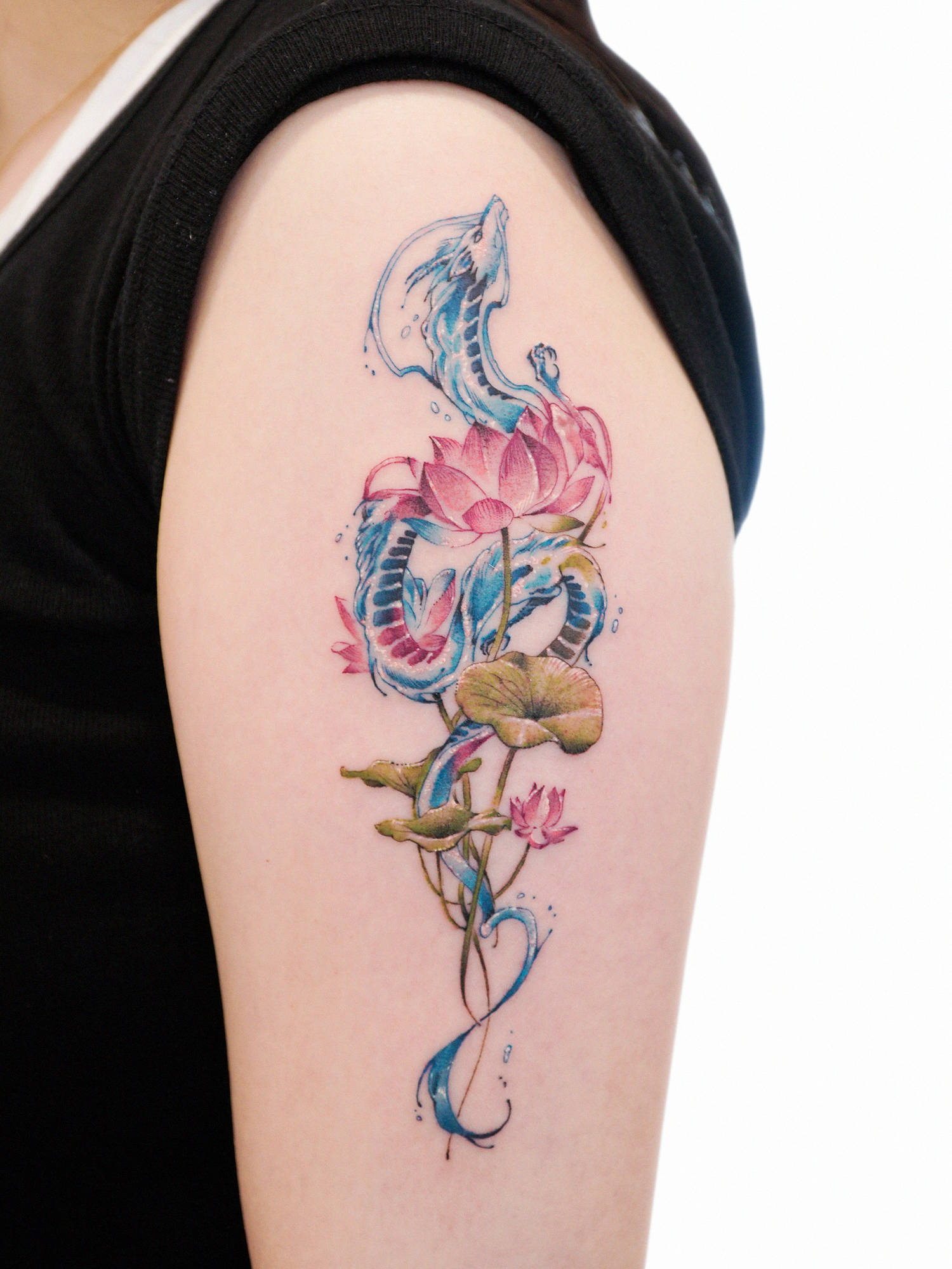 water dragon and lotus tattoo on arm