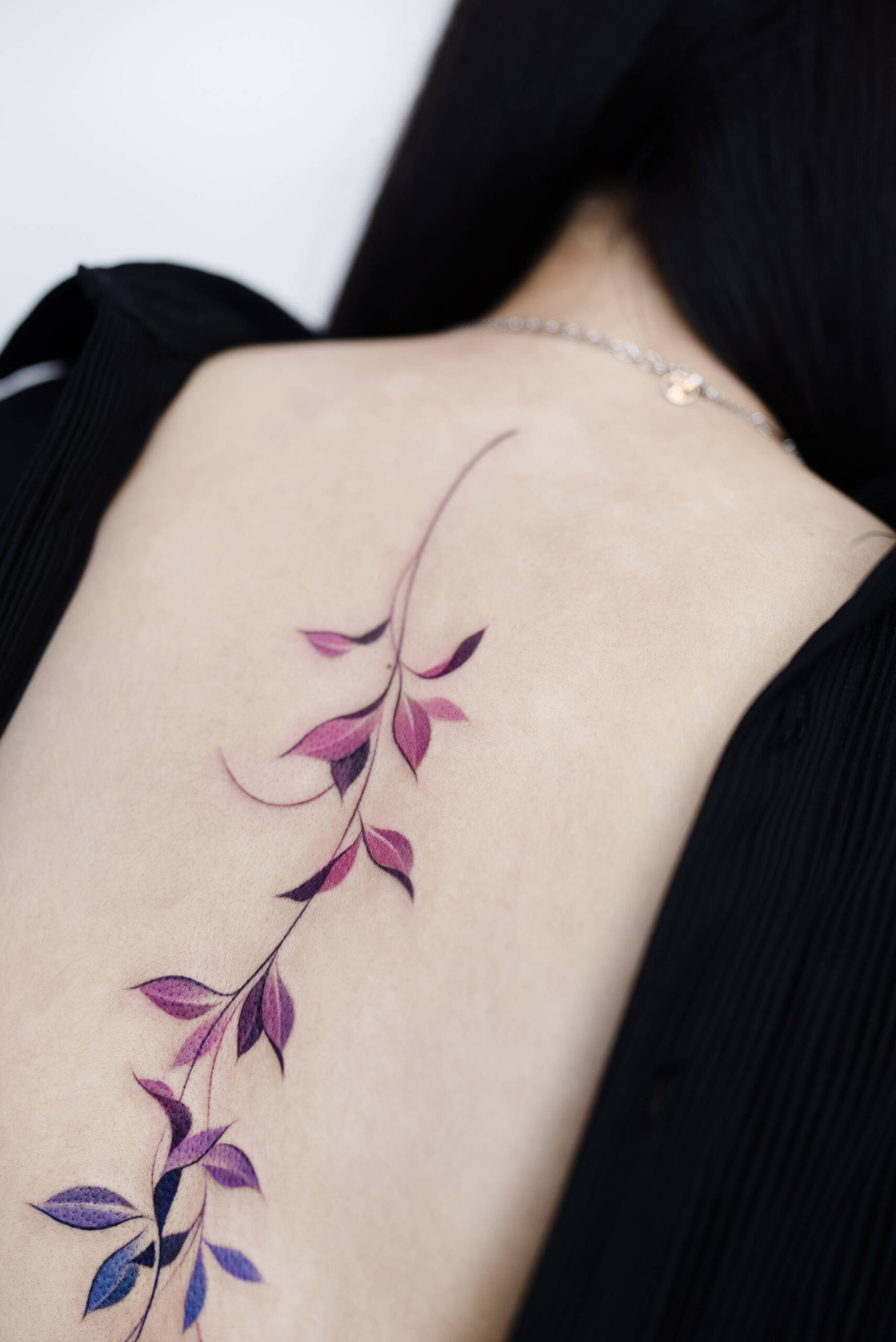 gradient pink to blue leaf tattoo on back