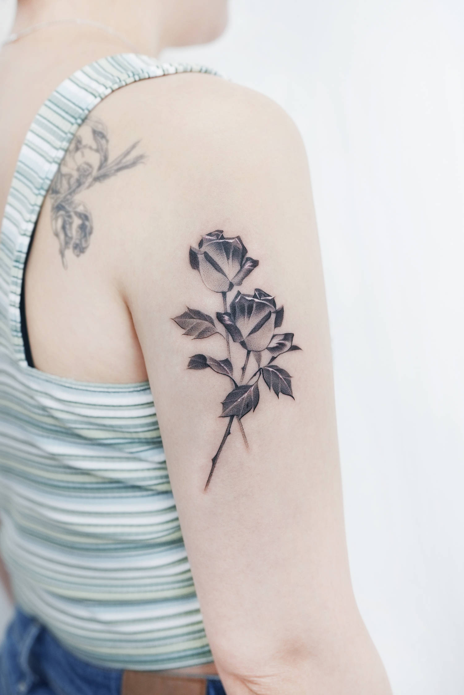 black and grey rose tattoos on arm