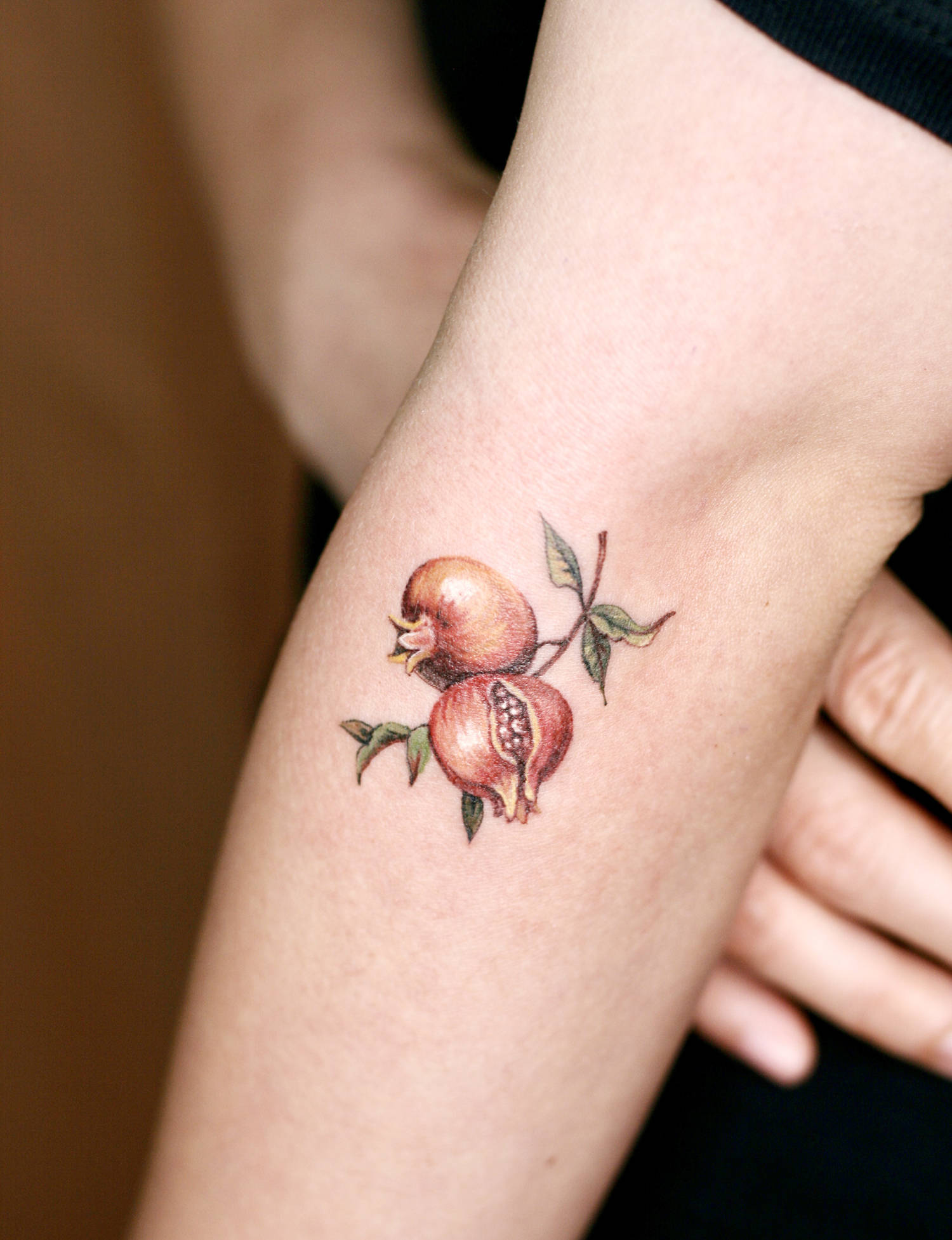 pomegranate tattoo on arm