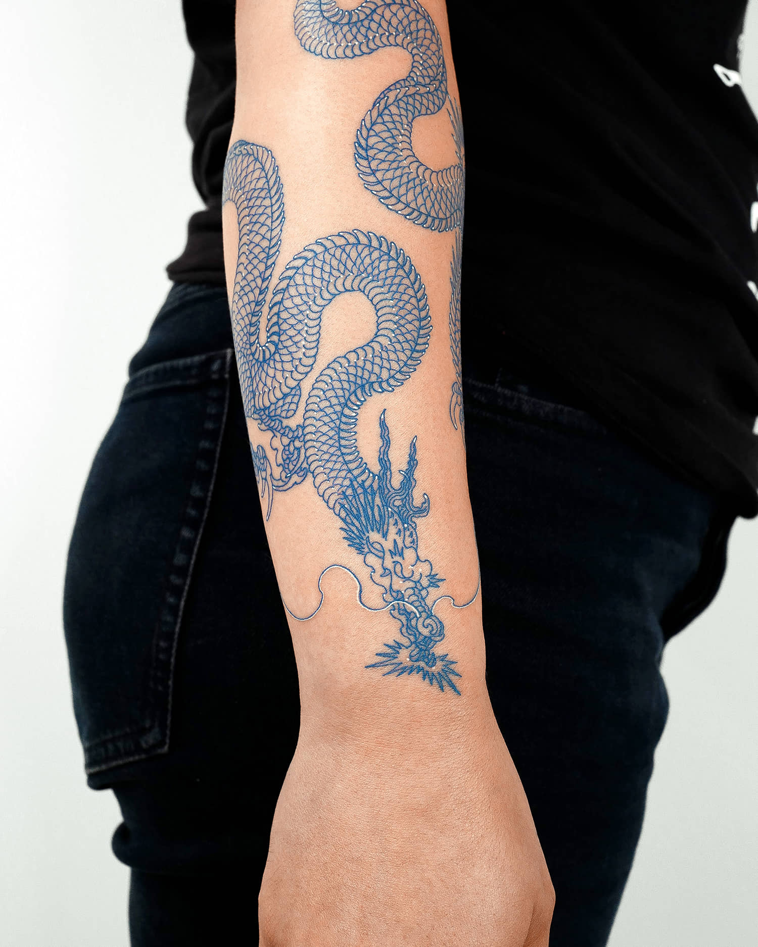 Fine dragon tattoo in blue and white